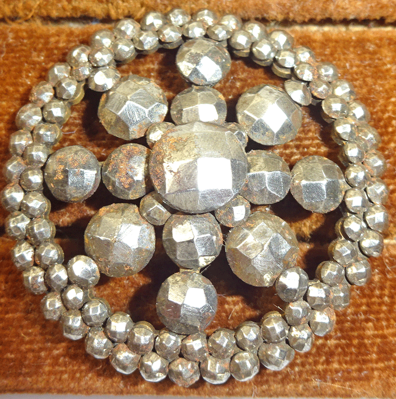 Large facetted cut steel button