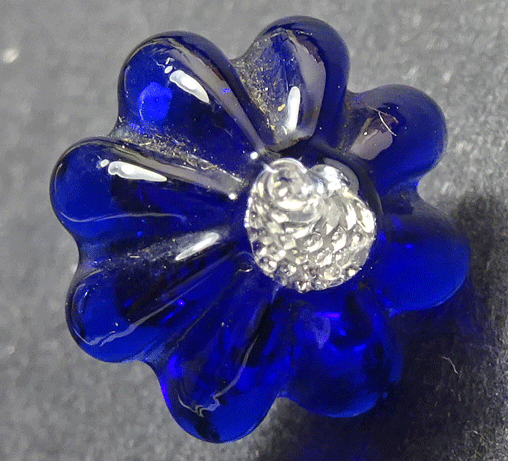 Antique blue glass button with silver foiled centre