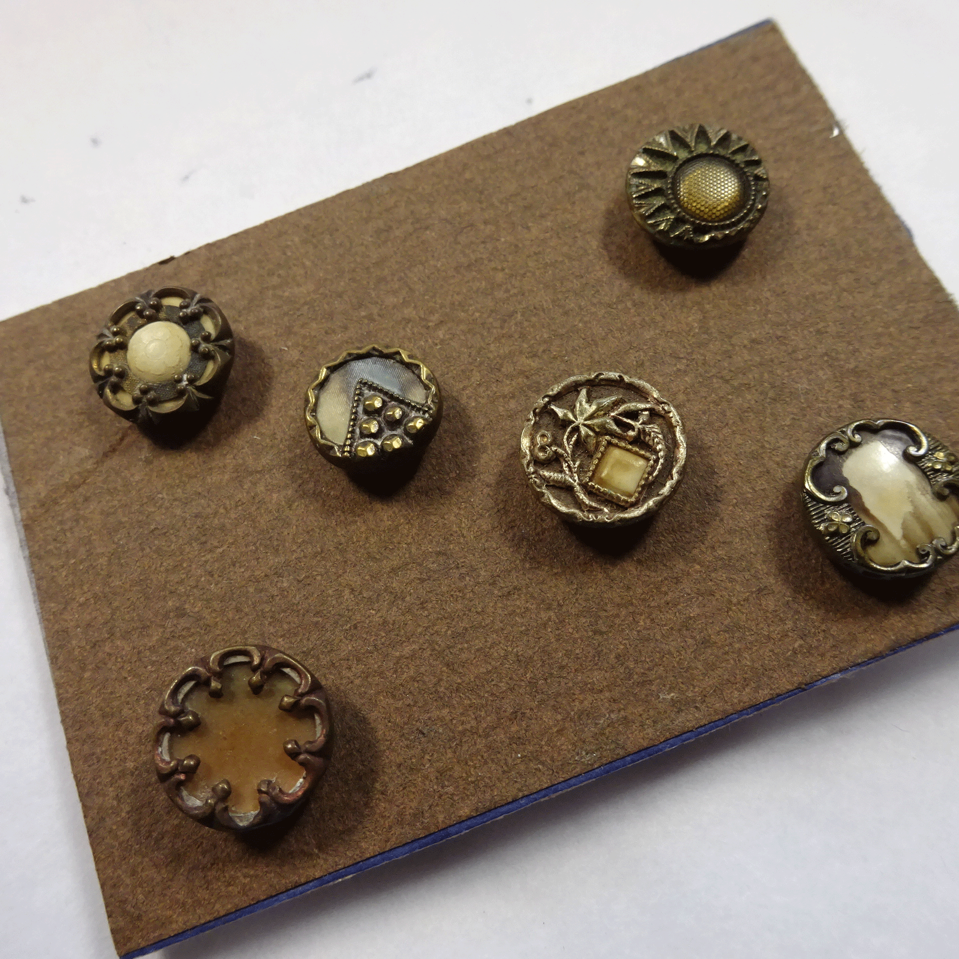 Group of 6Austrian tinies with celluloid and metal motifs