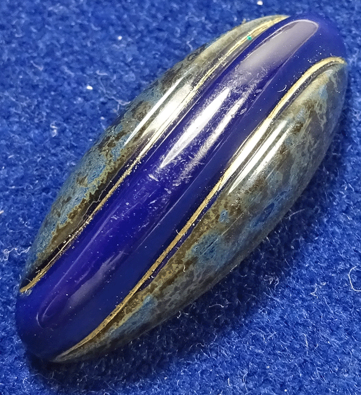 Long narrow blue glass spinkle shape with marbled sides