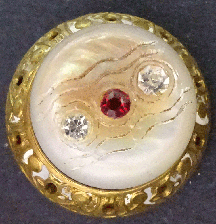 Jewelled mother of pearl with pierced metal rim