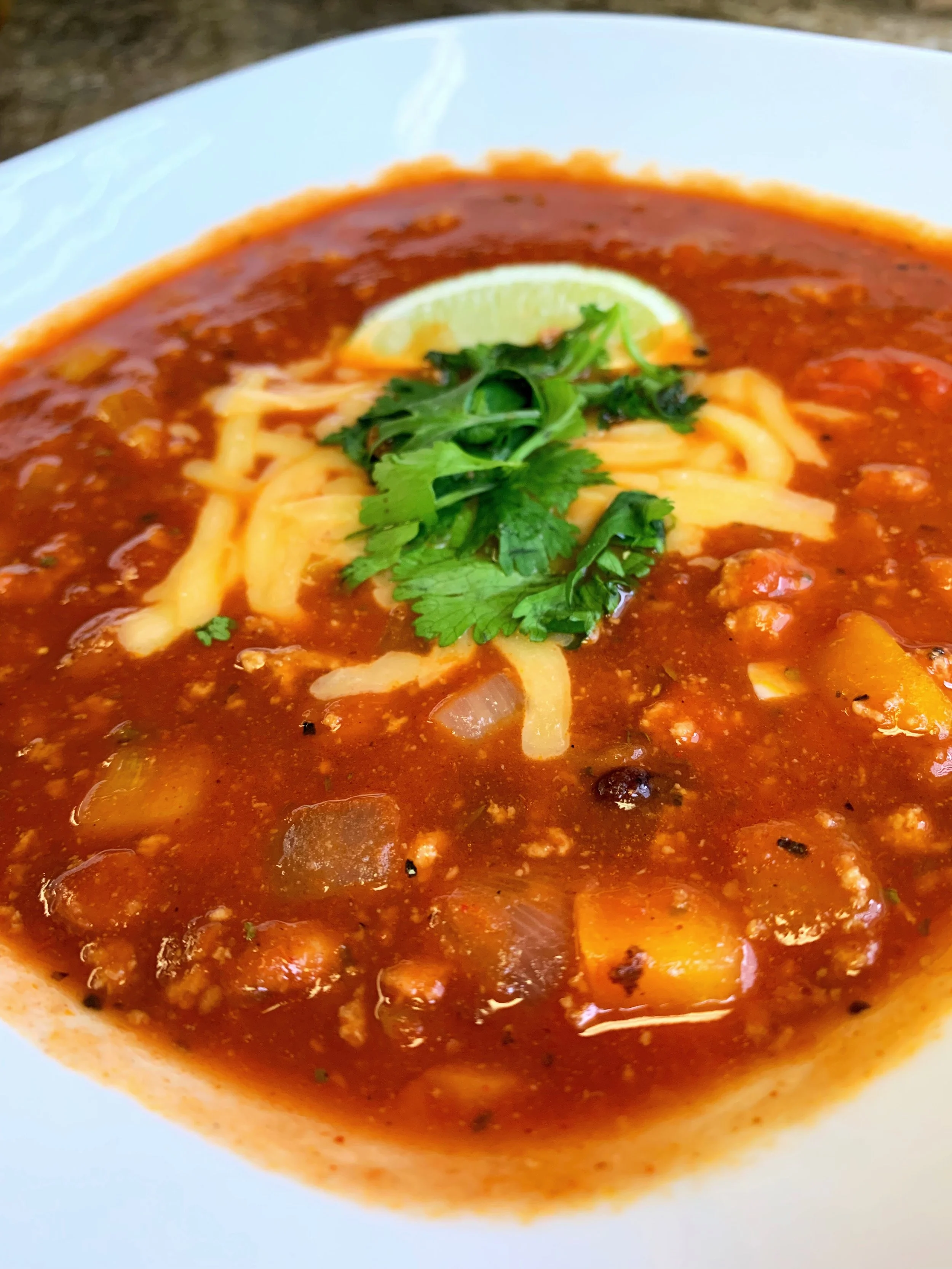 Spice your chili up with hot sauce, cilantro and a squeeze of lime.