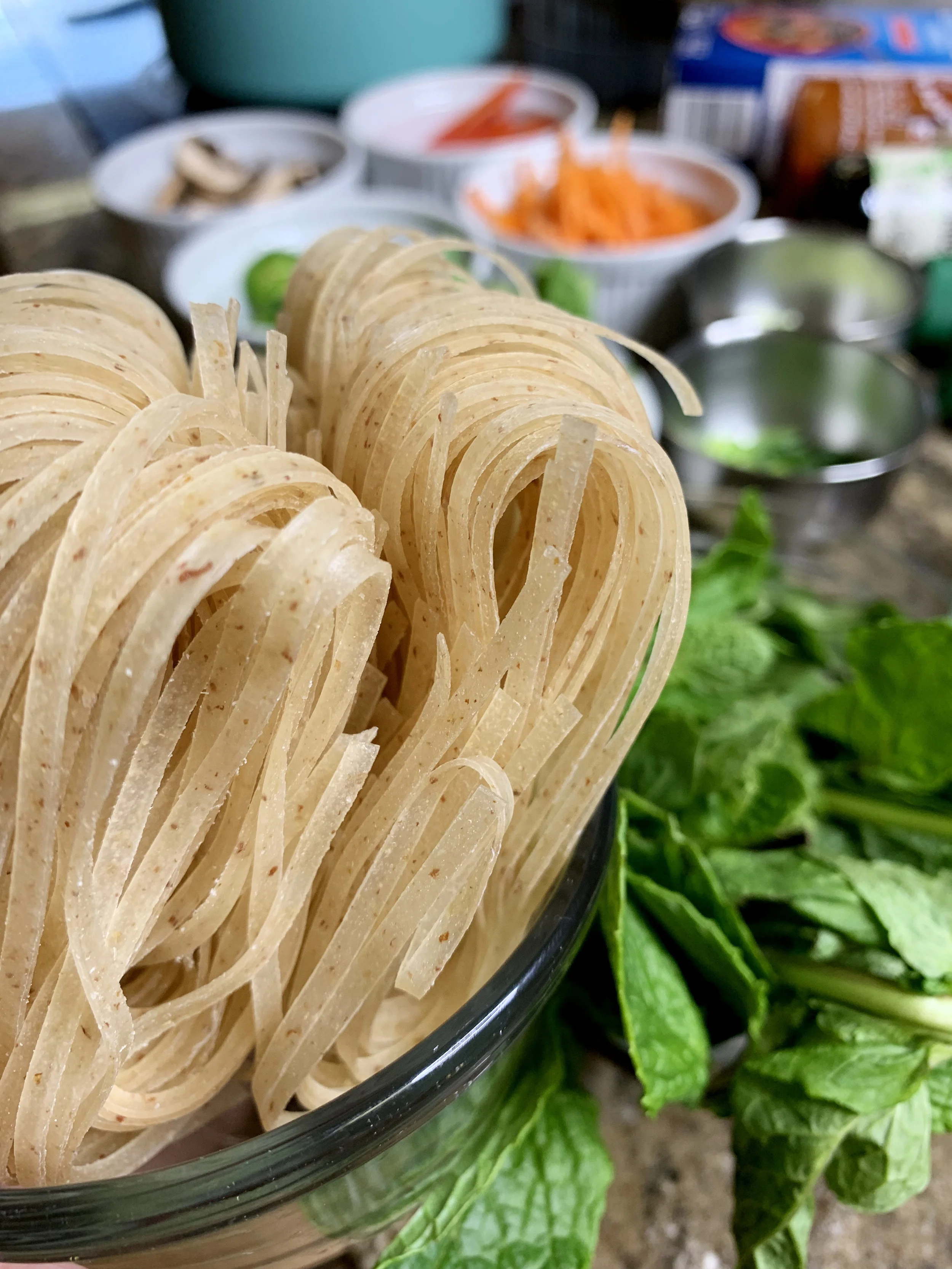 Brown rice noodles have a little more crunch to them than regular rice noodles, use either!