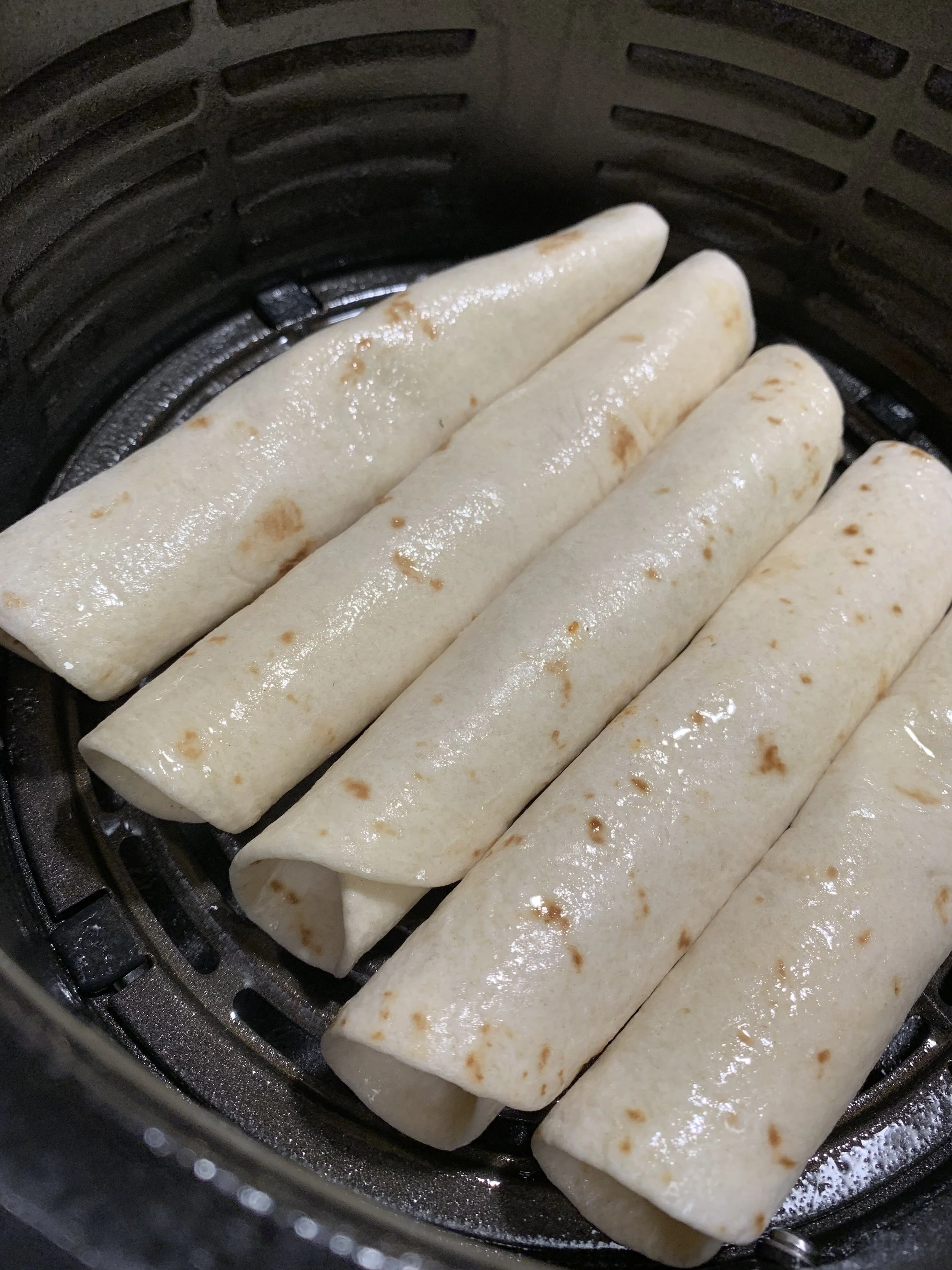 Easy as 1-2-3 just fill, roll, and place seam side down in the air fryer! Spritz with some cooking oil and you’re almost done.