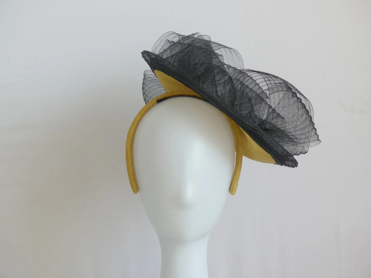 Introducing &lsquo;The Obsidian Wave&rsquo; a fabulous saucer shaped hatinator in &lsquo;Antique Moss&rsquo; sinamay. I&rsquo;ve used black pleated crin to extend and soften the edge of the piece and have hand sculpted waves of the pleated crin over 