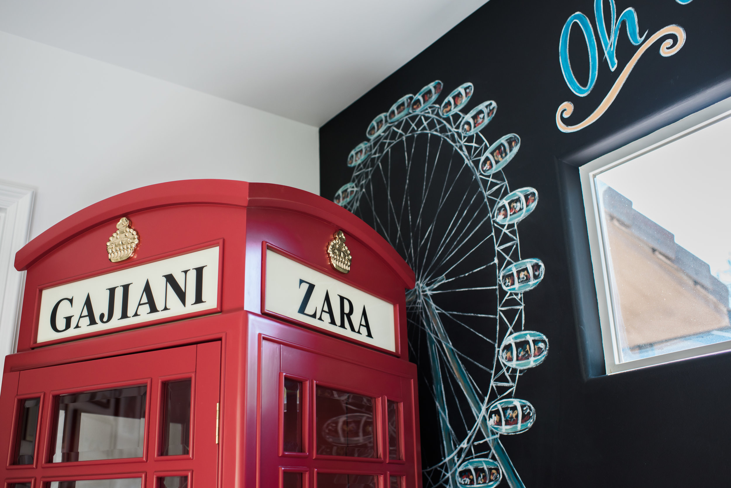 A London Red Telephone Booth with custom name plaques in a Play Room designed by Rockabye Mommy