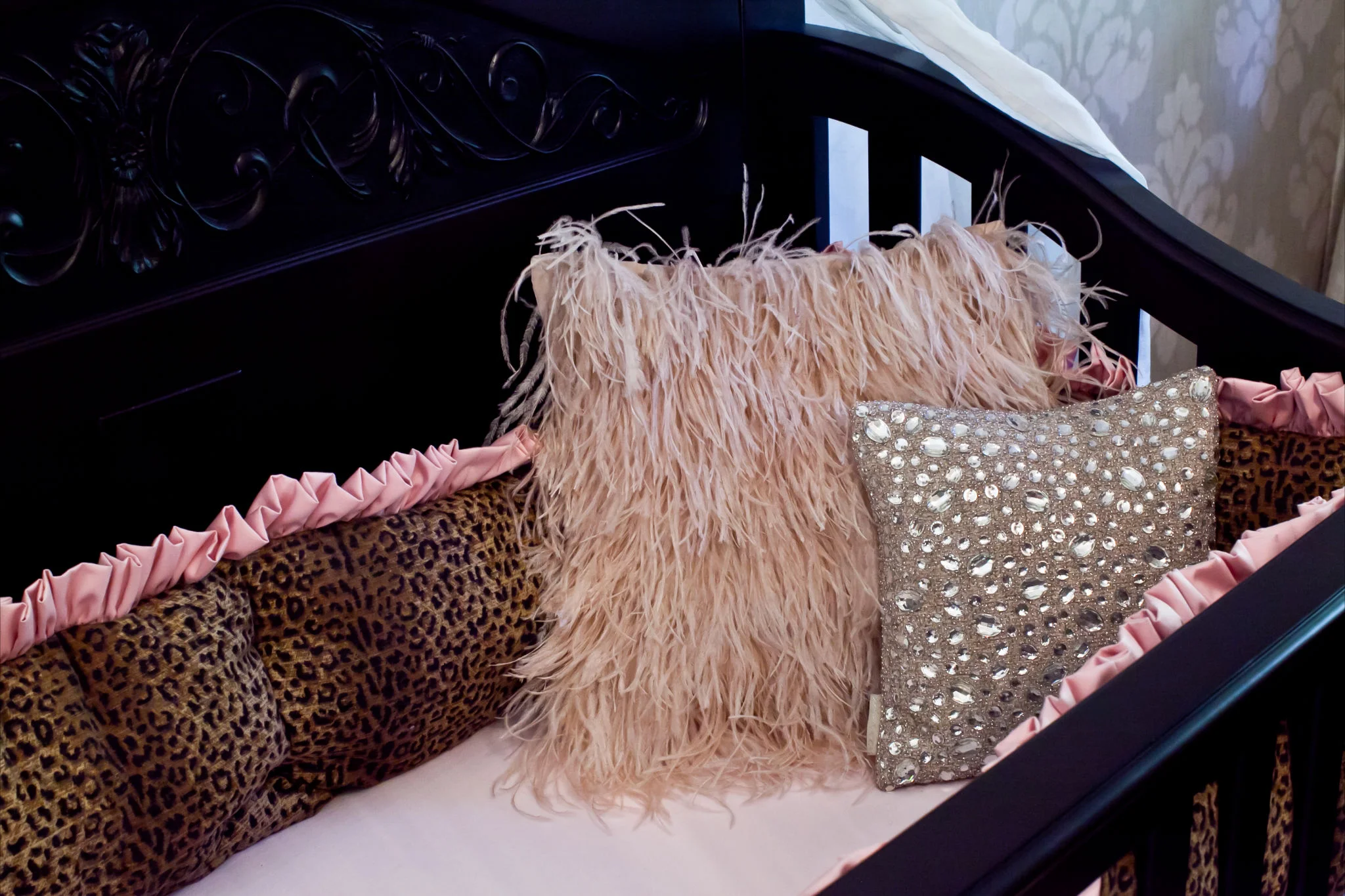 A custom leopard crib bumper designed by Rockabye Mommy