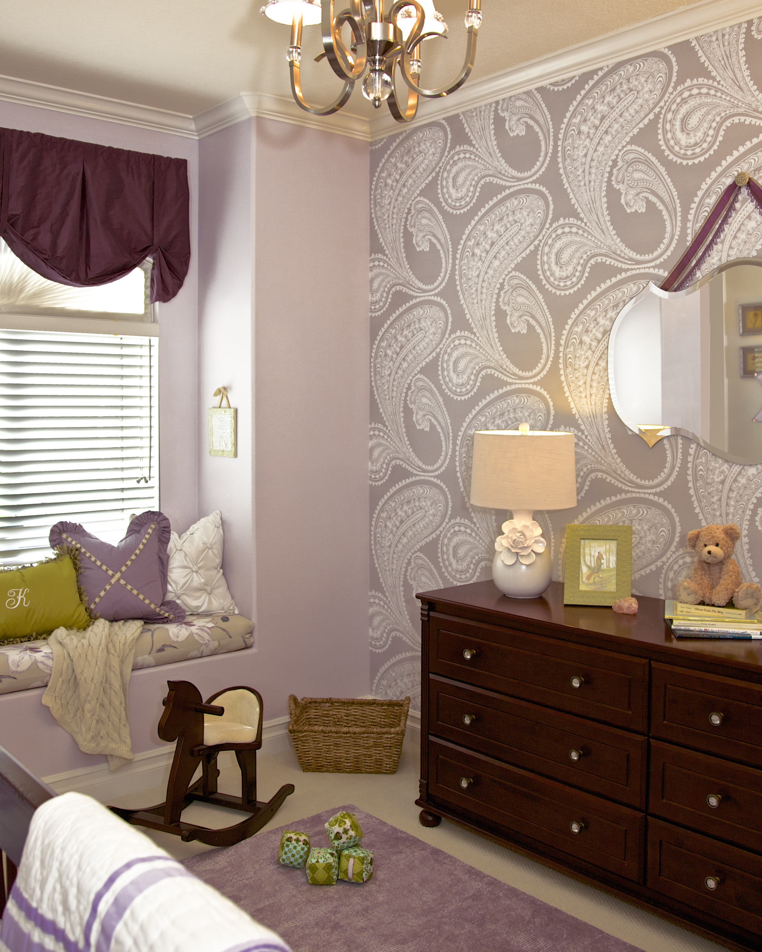 Purple paint and Paisley Wallpaper in a Girl's Nursery designed by Rockabye Mommy