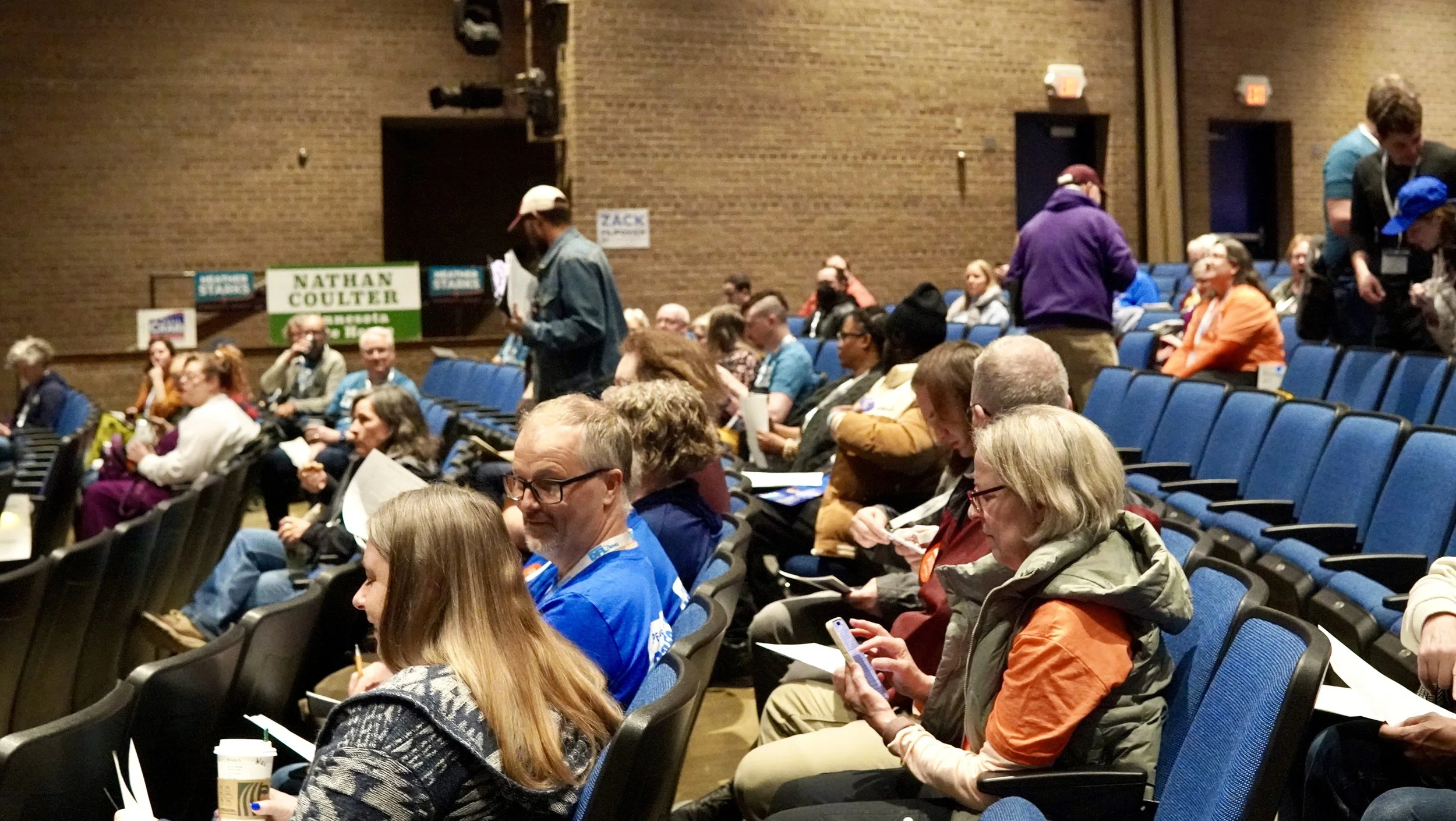 Citizens of SD51 at convention, seated in a school theater