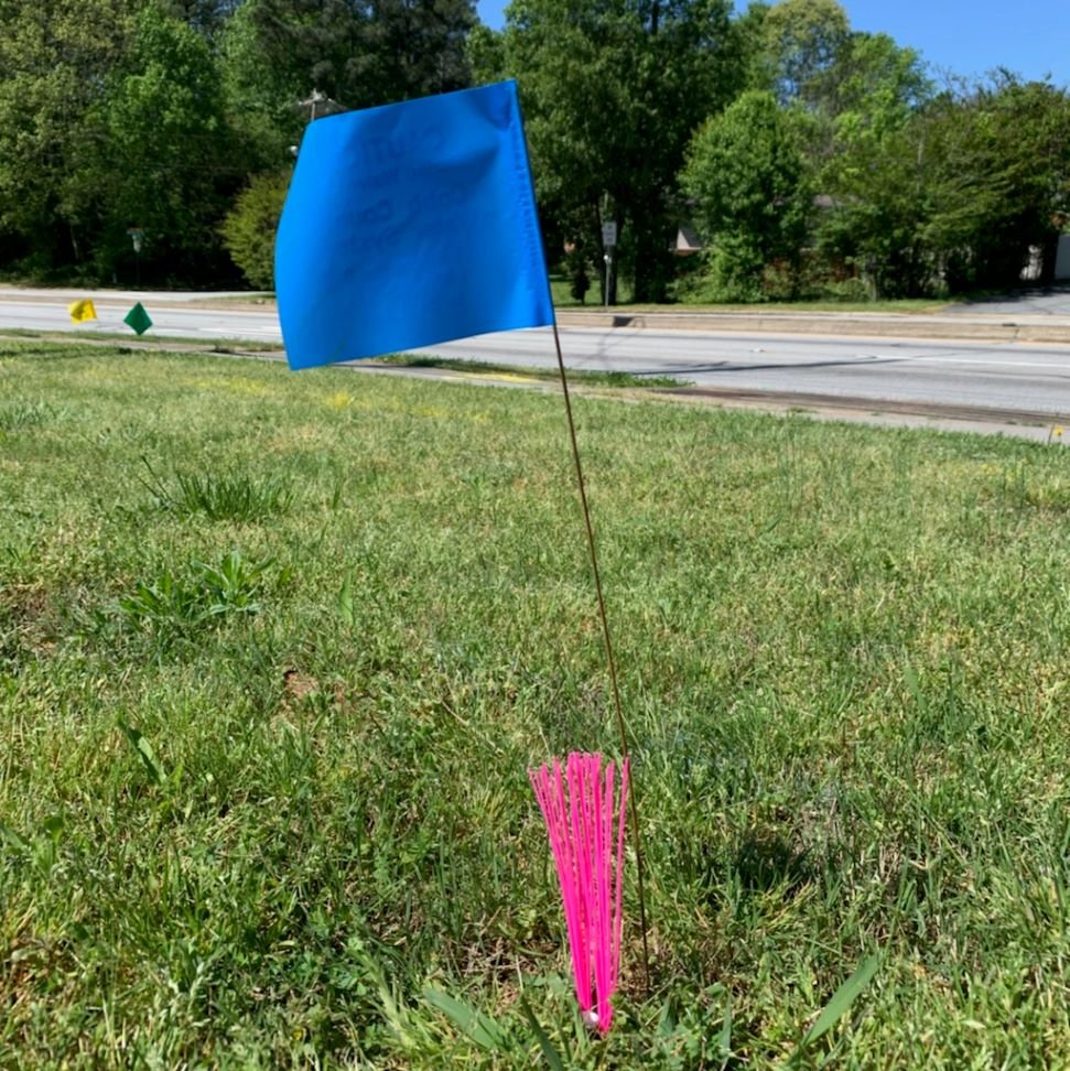 Trail Chasers Ground Marker next to Wire Marking Flag.jpg