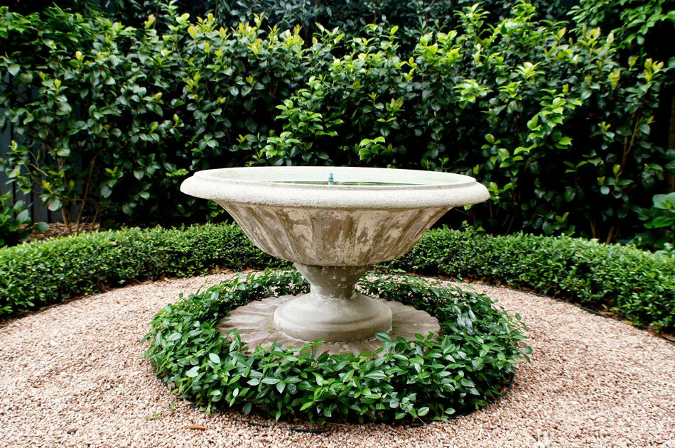 Close up of water fountain in side yard.