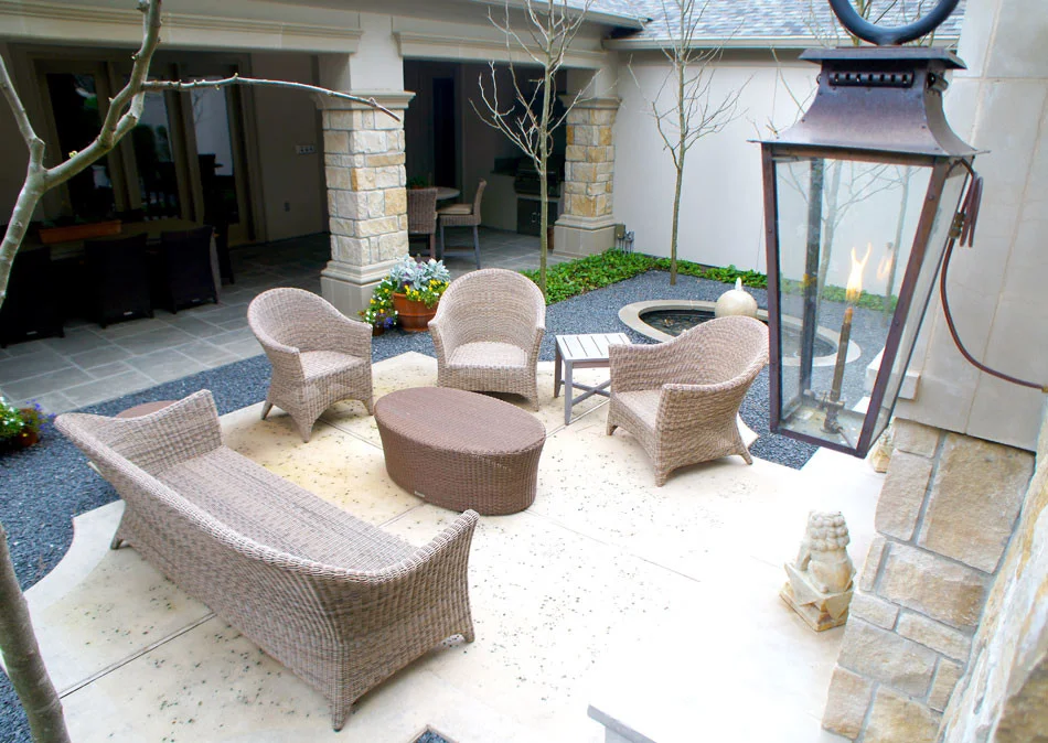 View of formal outdoor seating area near outdoor fireplace.