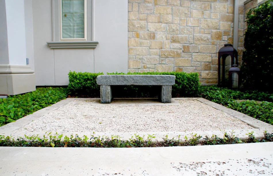 Custom stone bench sits on a concrete frame with a rock salt finish.