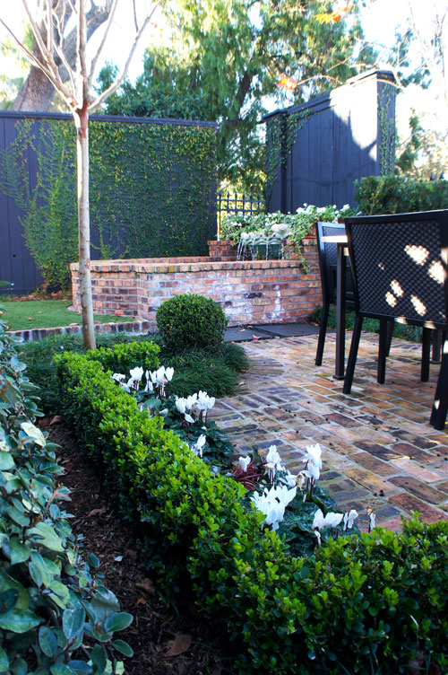 Left: Brick border separates synthetic lawn from Asian Jasmine and blackstar gravel feature.
