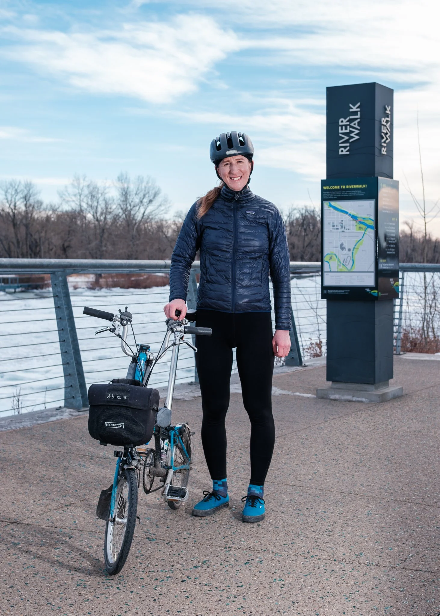 Brett Bergie, multi-modal community advocate is photographed with her bicycle on RiverWalk in Calgary's East Village neighbourhood.