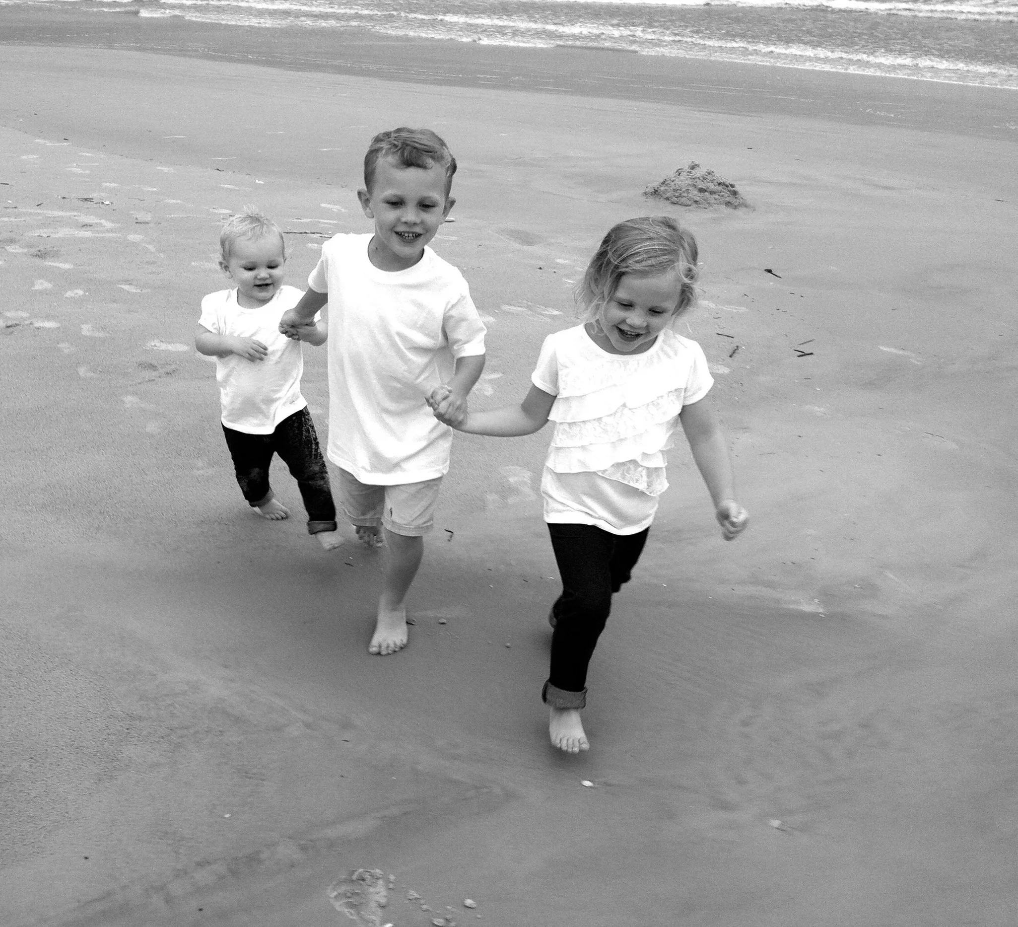 That’s our children, Charlotte, Nate, and Ella, walking on St. Augustine Beach in the pre-school years.