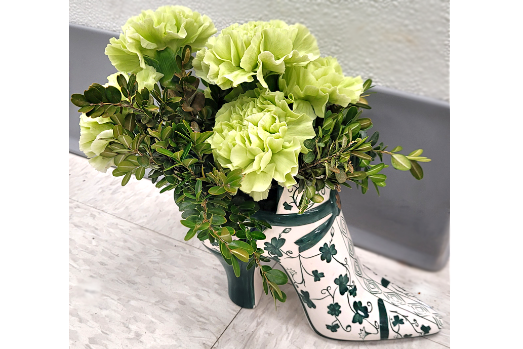 Tinted Carnations, Boxwood adorn a lucky shoe, by Joyce