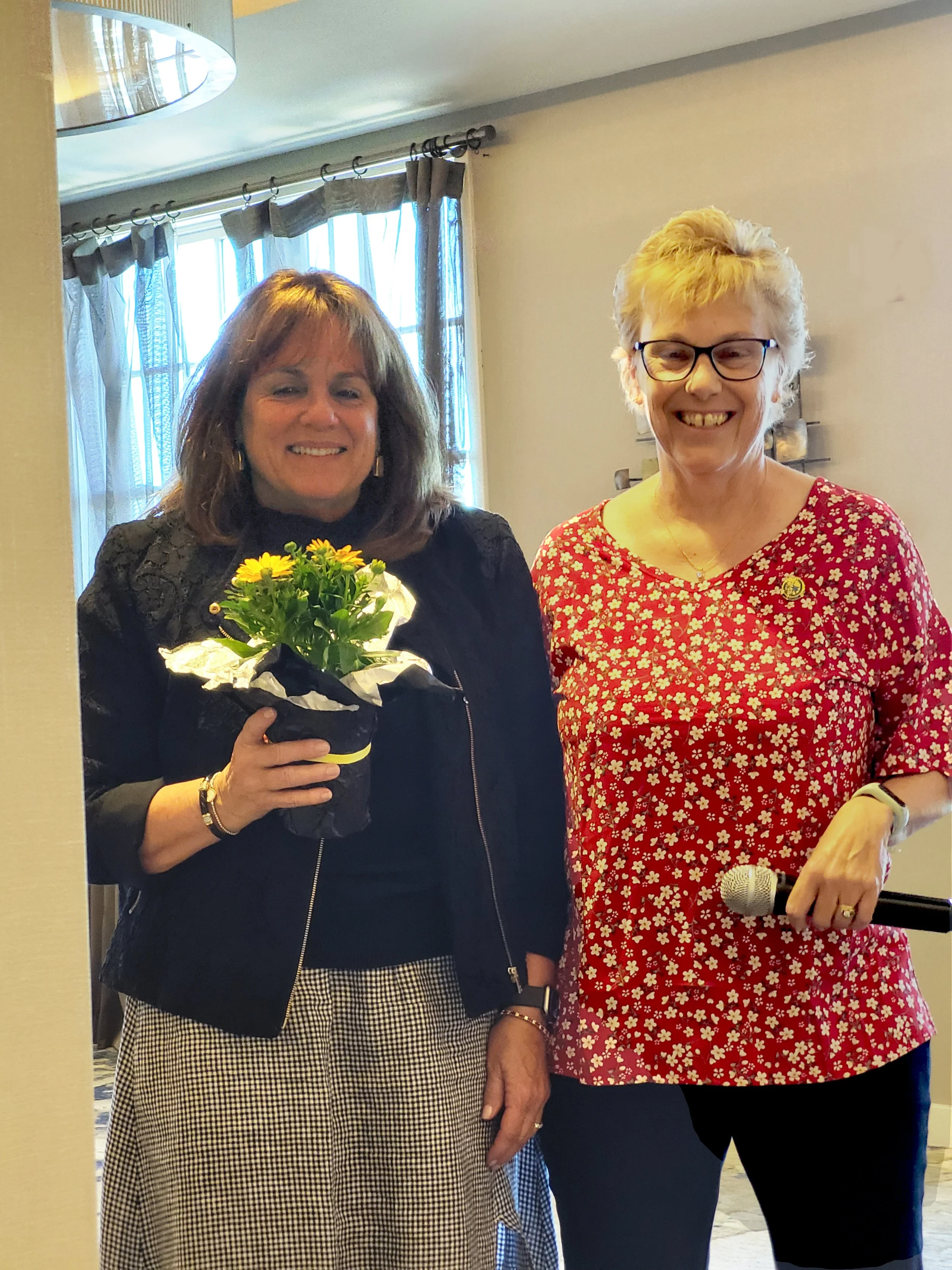 Susan receives "Thank You" flora for her help with this year's Celebration Luncheon.