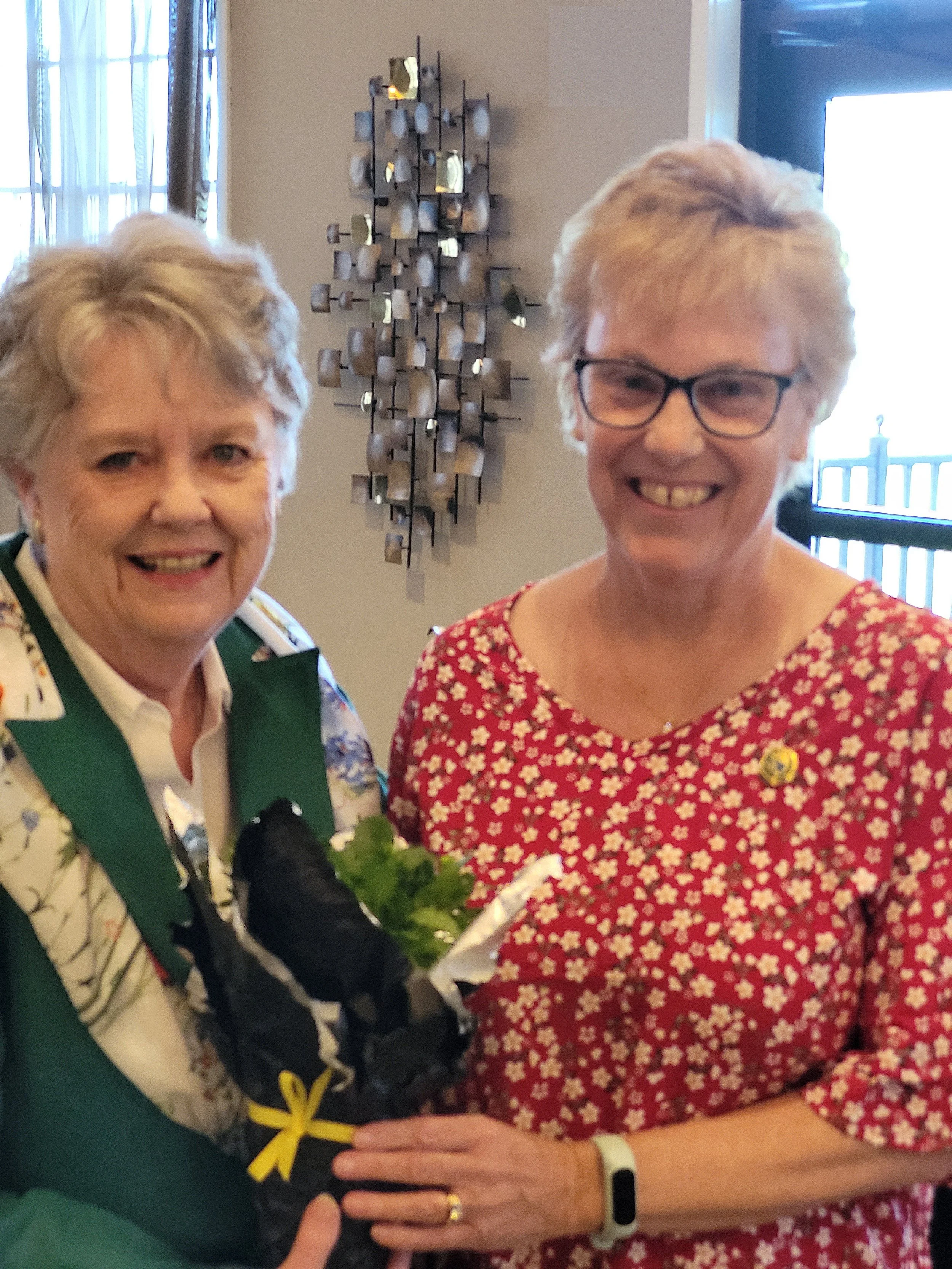 Bev gives a "Floral Thank You" to Judy for her assistance with this year's Celebration Luncheon. 