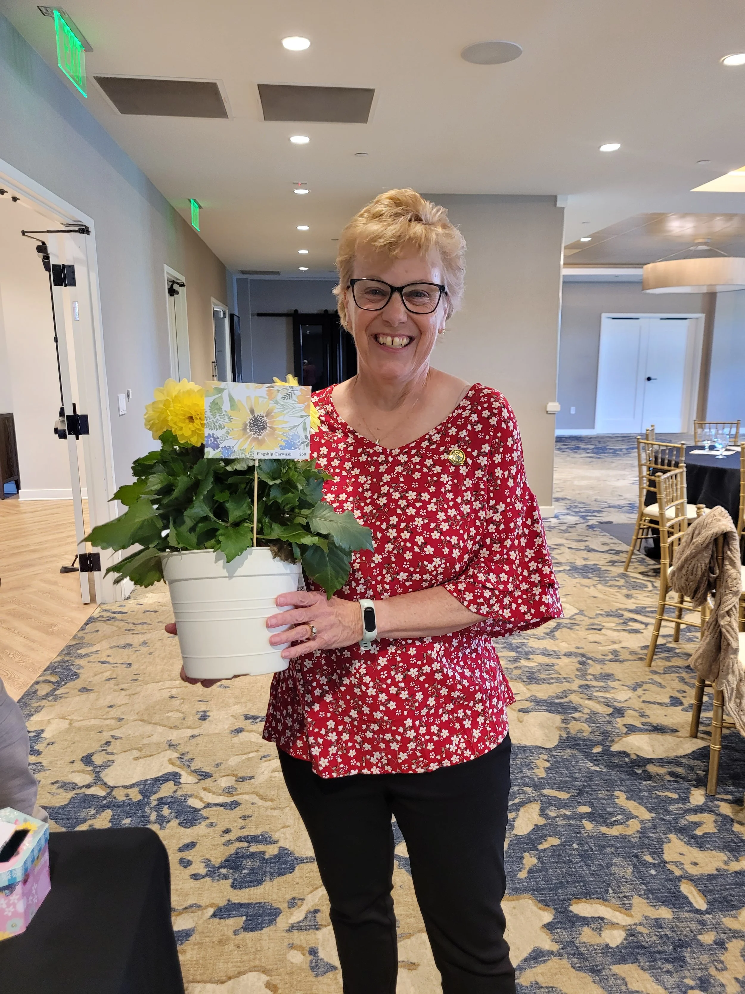 Our professional President, known to plant around town and in her backyard; has some new buds, for the garden.