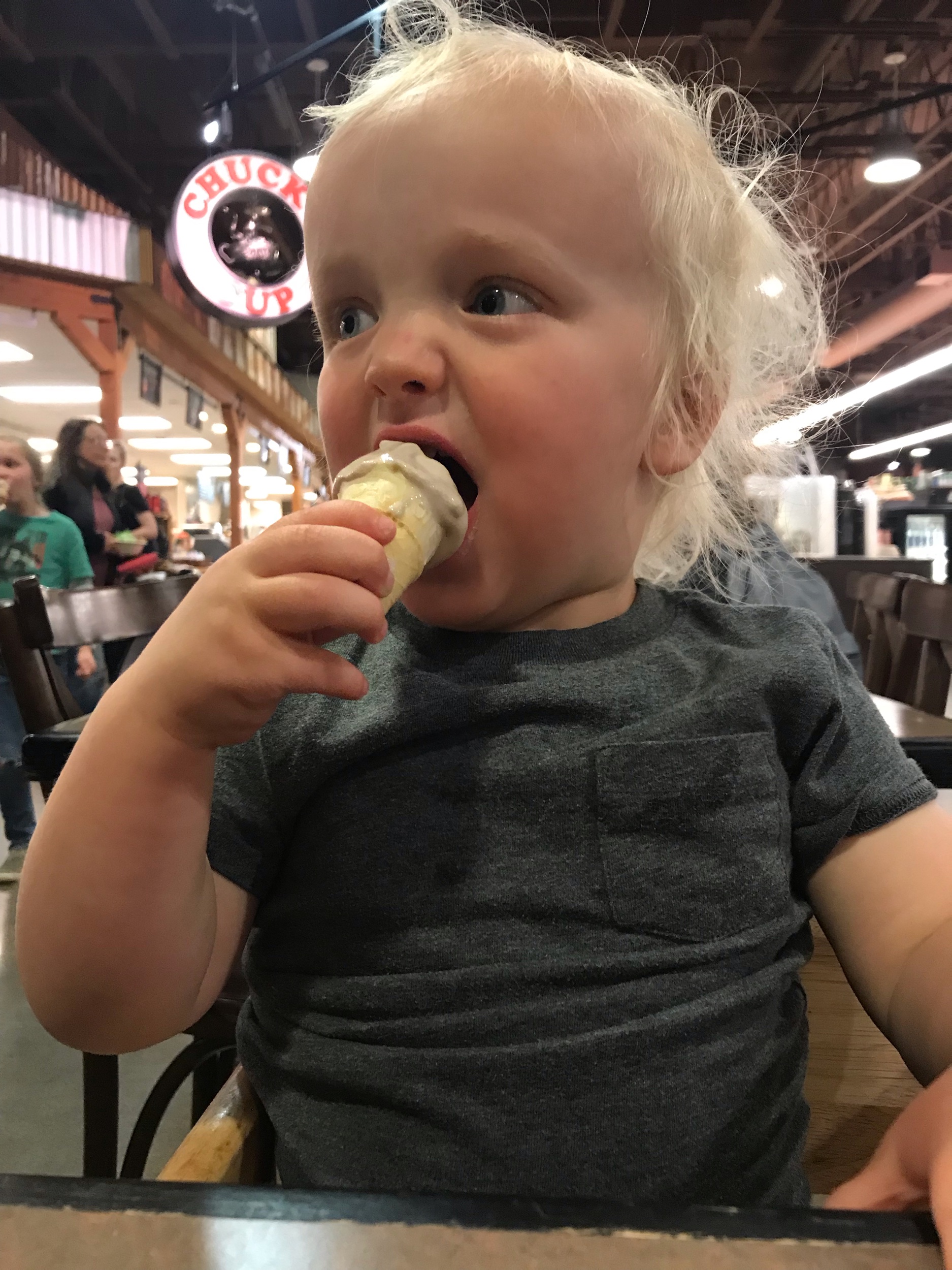 Toddler-age boy eating ice cream cone.
