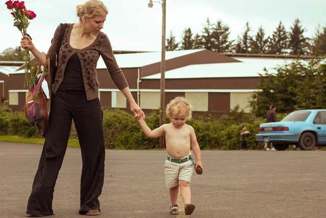 Portrait of mother and son with flowers that will die soon.