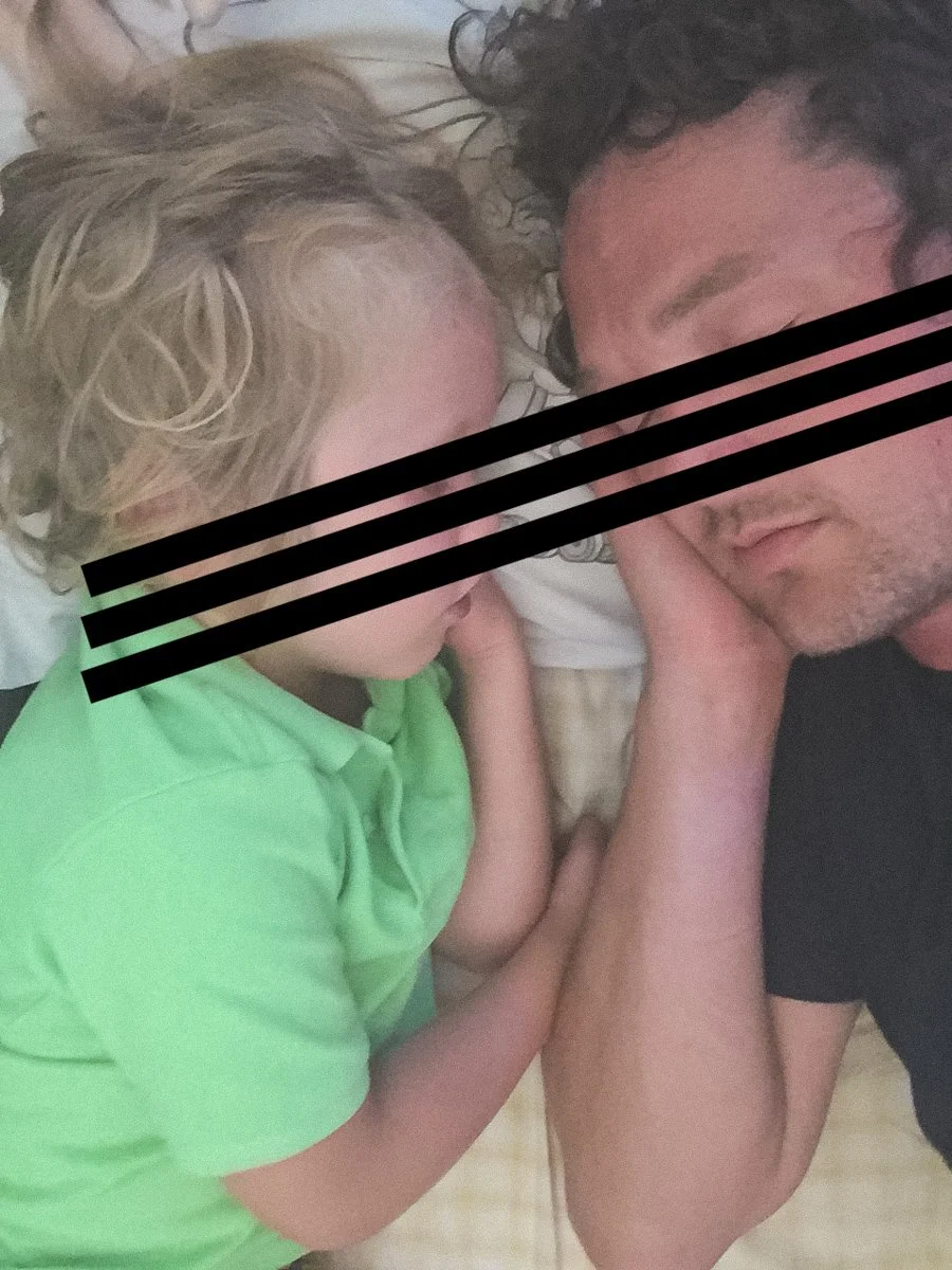 Dad tucking in his 5-year old son to bed