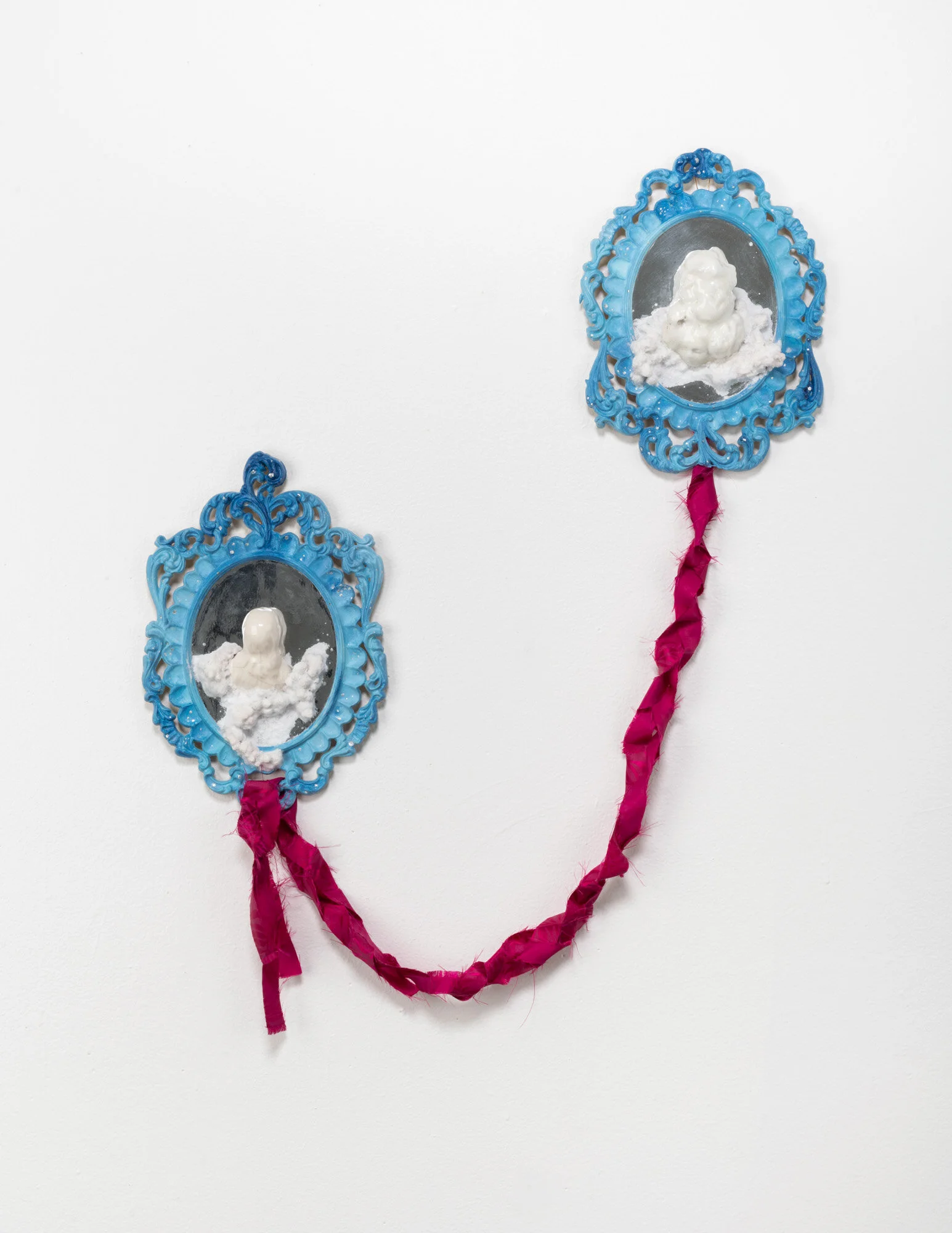  Found objects (acrylic picture frames, porcelain figurine, styrofoam fruit), polymer clay, molding paste, plaster, flocking, mylar, fabric, faux silver leaf. 20” x 25” x 3”.  