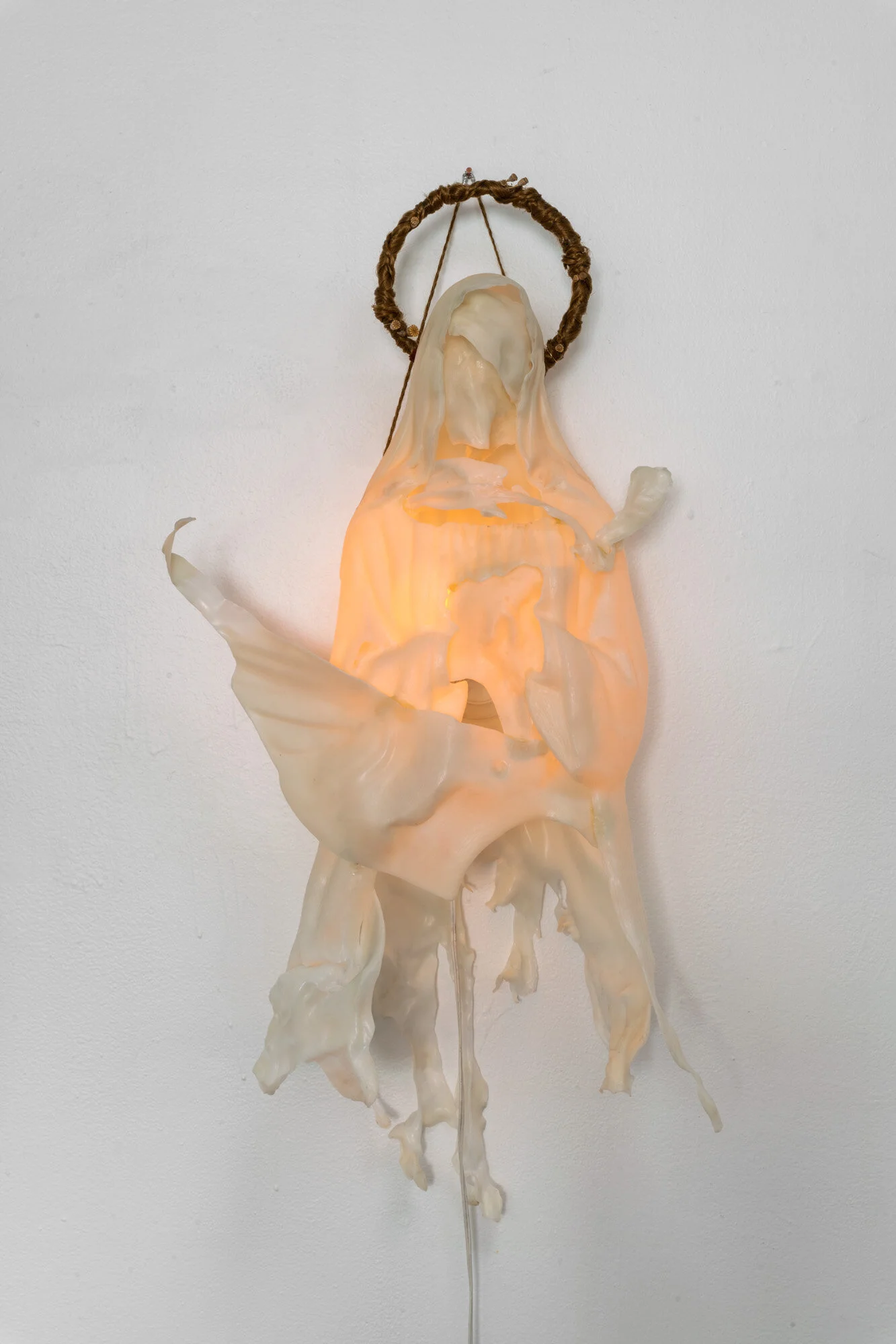  Altered blow mold lawn ornament, acrylic hair, poppy pods, decorative silver cord, novelty flickering flame light bulb. 18” x 10” x 30”. 