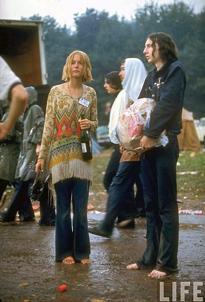 Woodstock-Photos-A-couple-standing-barefoot-in the mud at the Festival- Credit John-Dominis-Woodstock-1969-700x1031.jpg