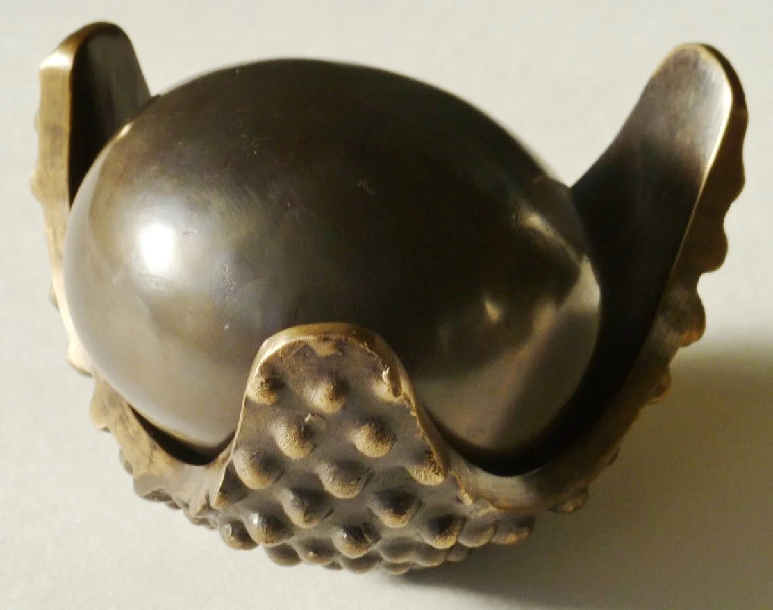 2010, Popped seed (two parts), cast bronze, pod 65 x 110 x 105mm; seed 55 x 78 x 78mm. Artis gallery, Auckland.