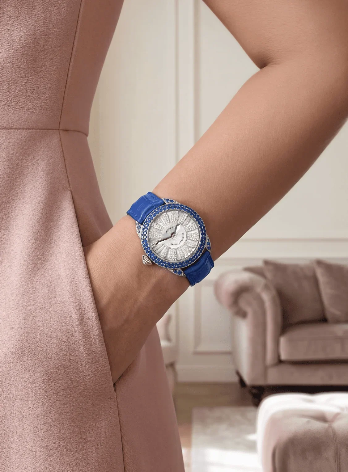 Piccadilly round diamond watch set with blue sapphires on woman's wrist.webp