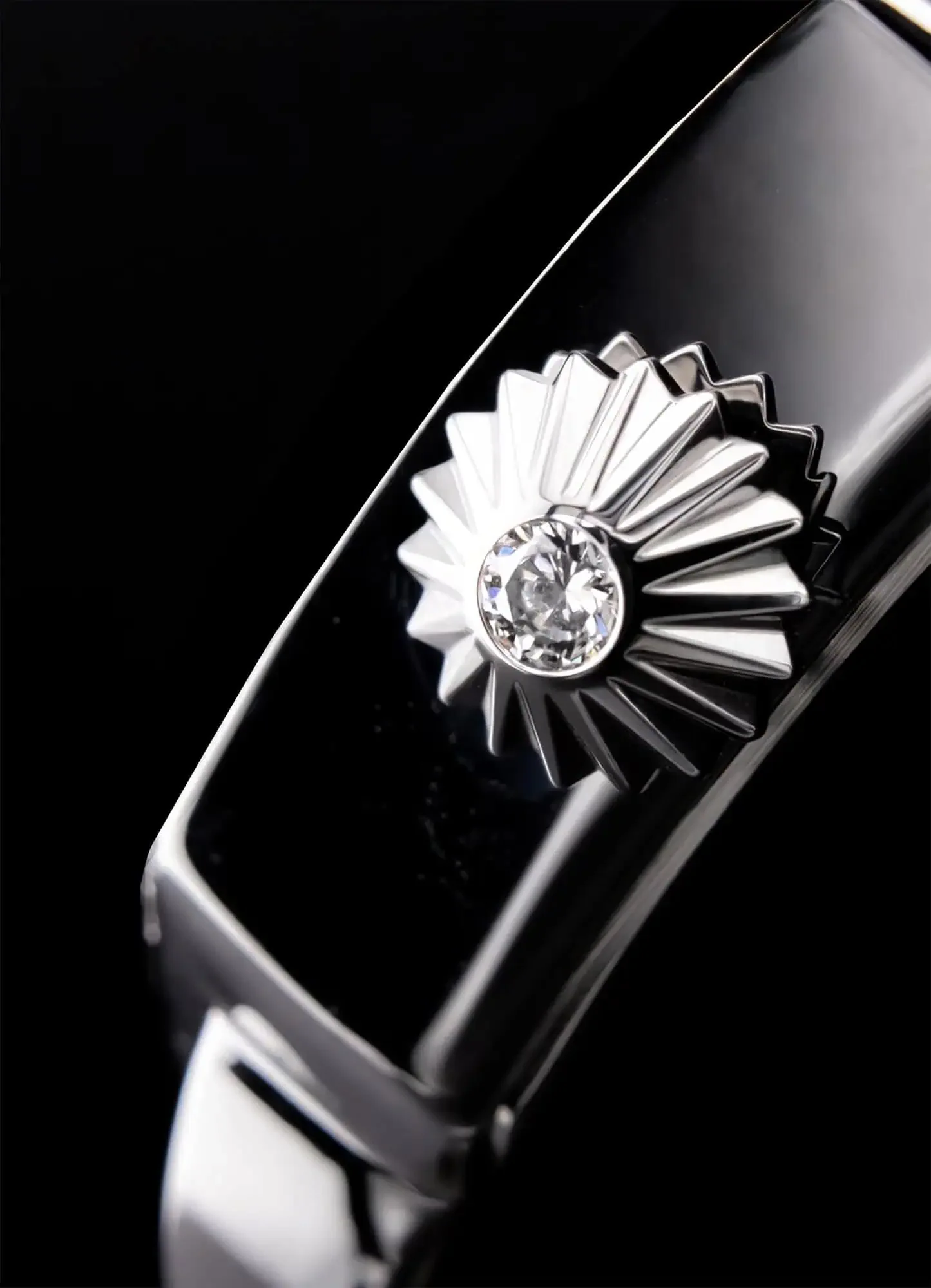 Close-up of Berkeley stainless steel watch xase sideshot featuring the round diamond in the crown.webp