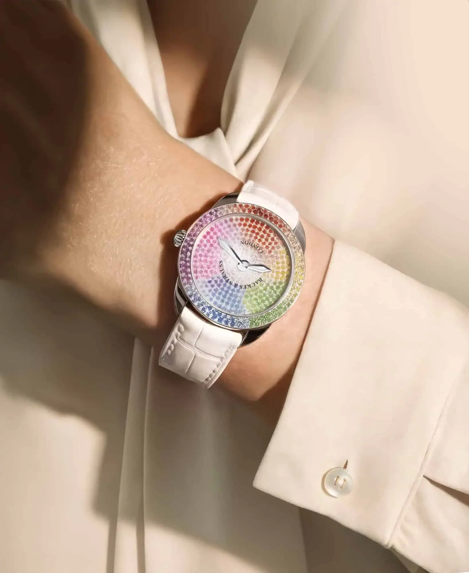 Female wrist shot of Backes & Strauss Mayfair 33 Colour Cascade luxury women’s watch with 351 hand-set gemstones..webp