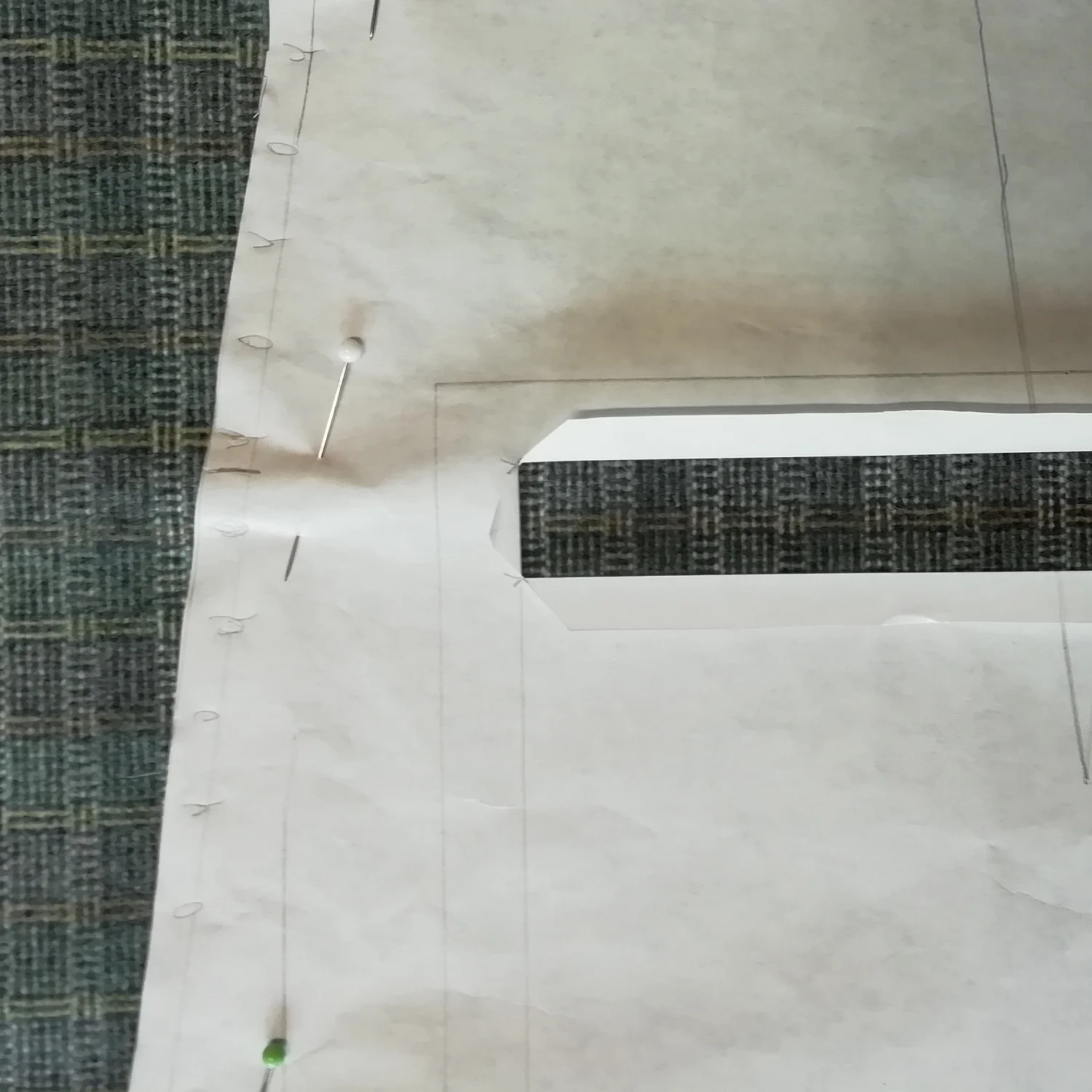 Positioning paper pattern on check fabric.