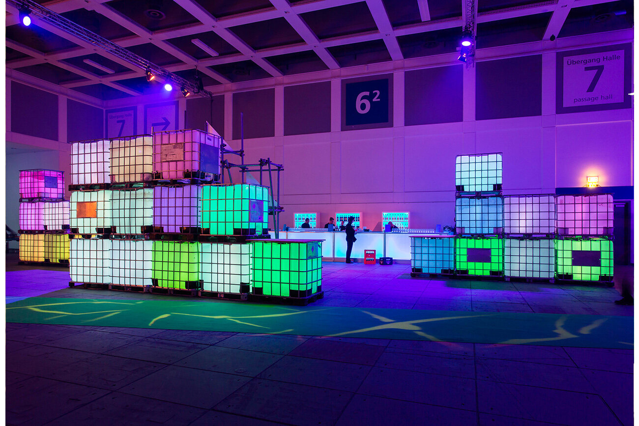 Water tanks and lights used to create pixel lounge space