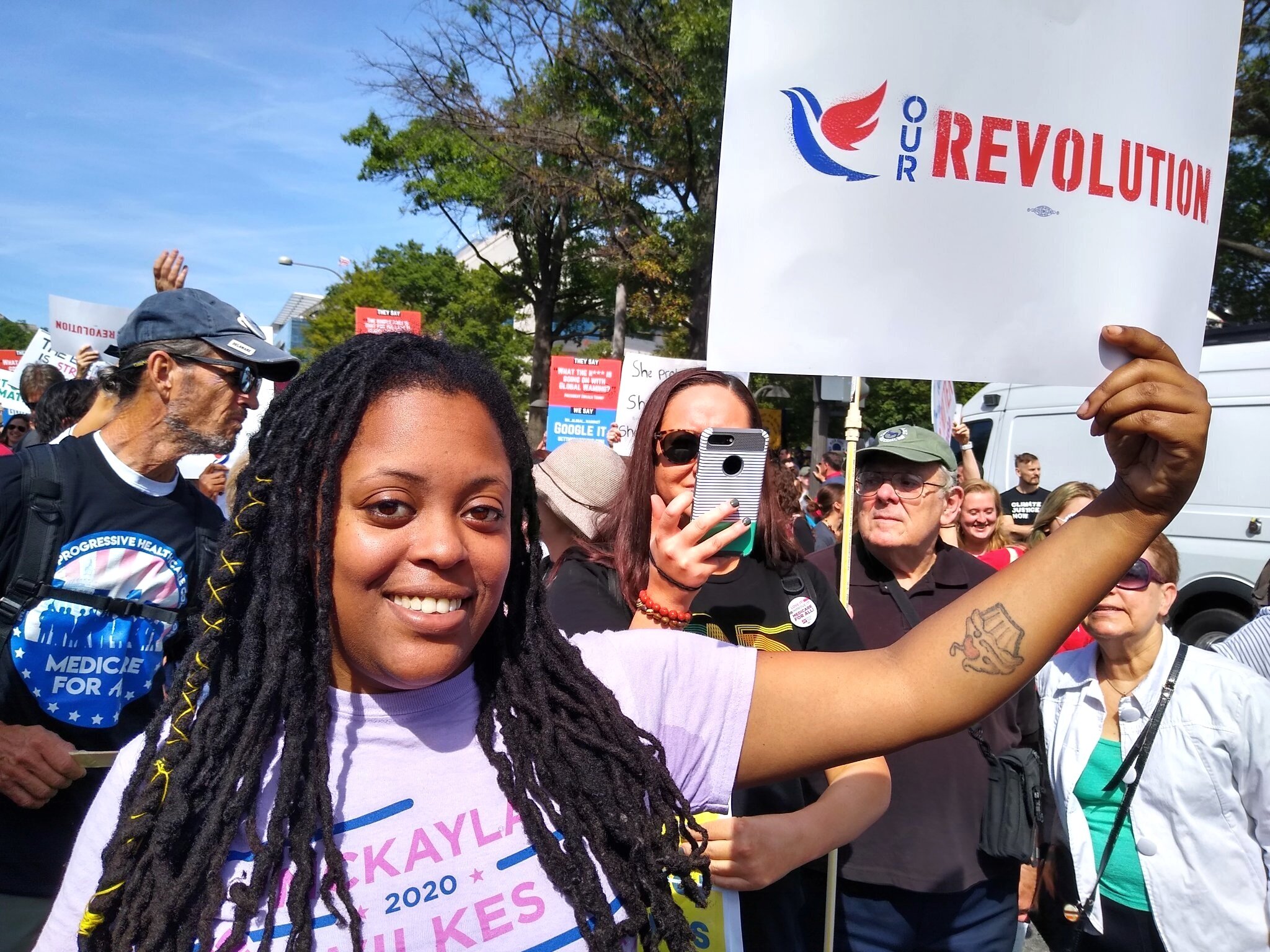 Mckayla Wilkes holding an Our Revolution poster at the September 2019 Climate Strike in D.C.