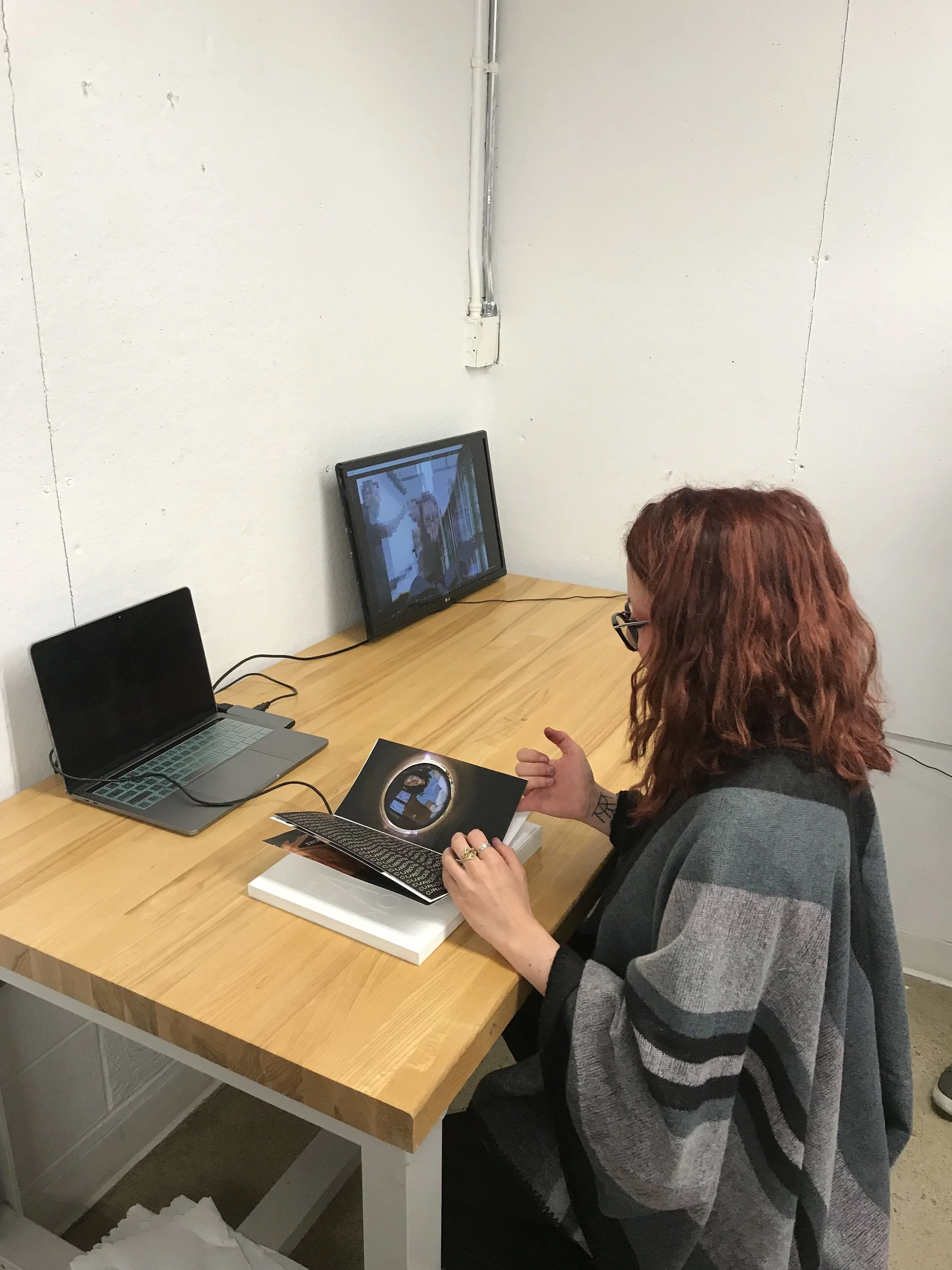 Viewer interacting with Facebook and affecting output on television screen.