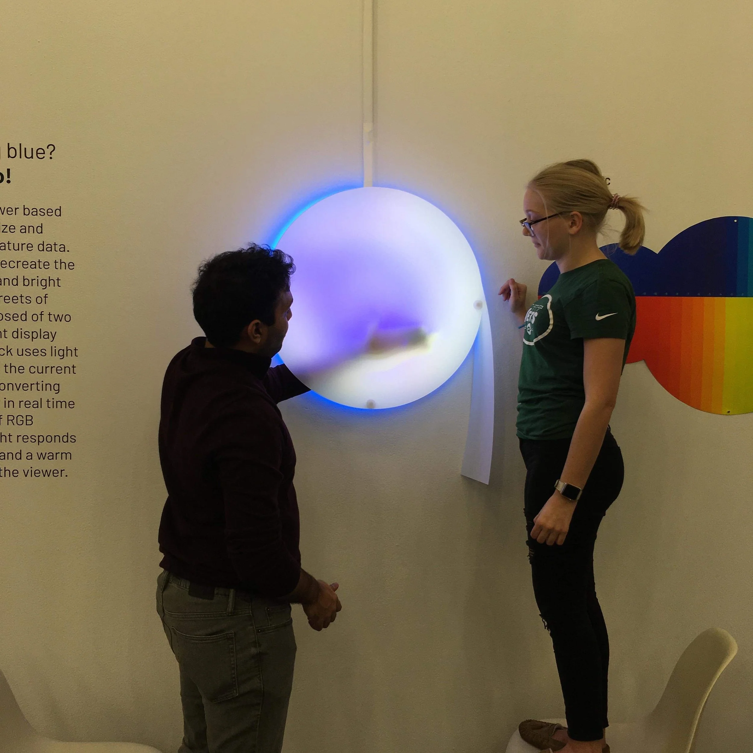  Akshay (left) and Jeanette (right) placing paper onto side of structure 