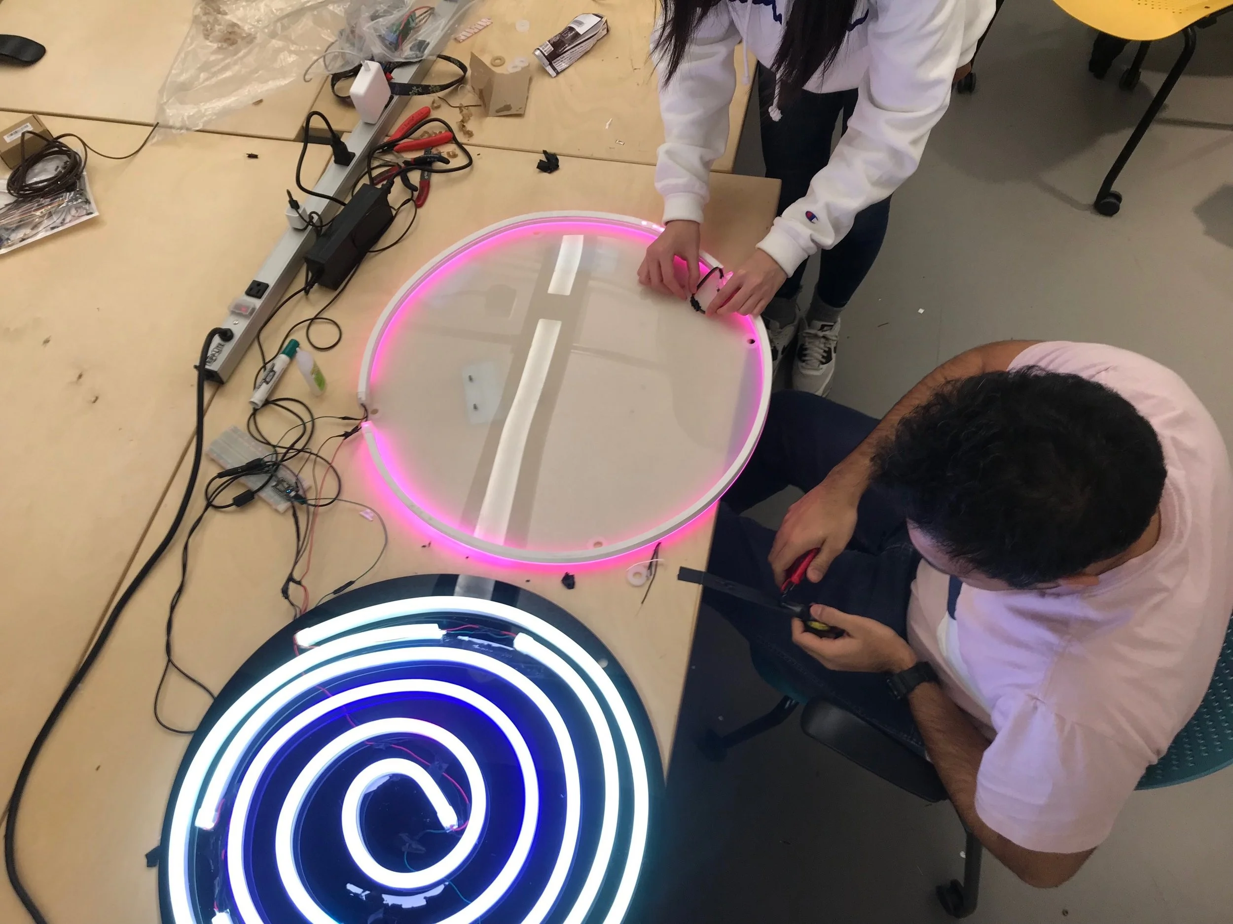  Hayan (top) and Akshay (bottom) configuring back LED tube to back acrylic piece 