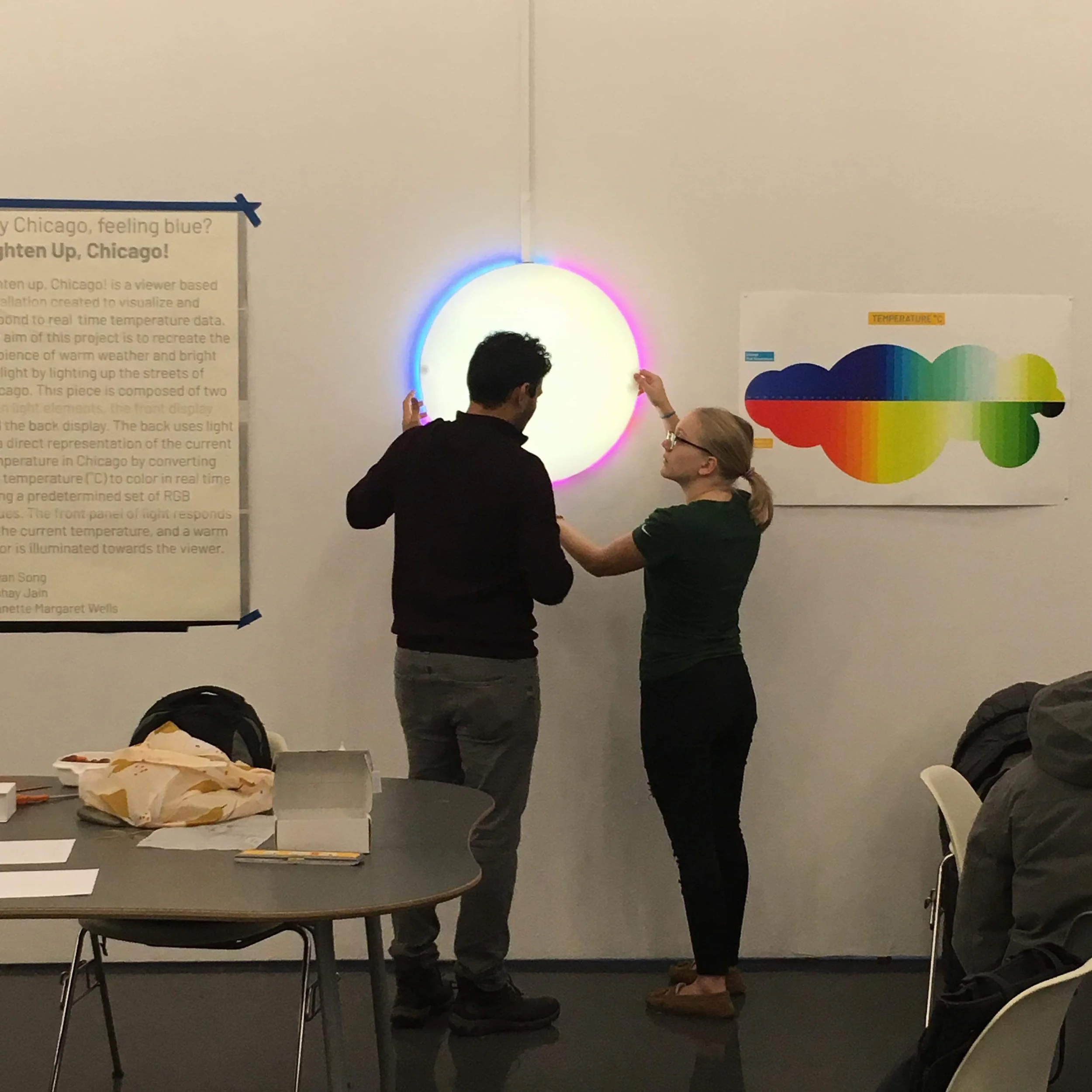  Akshay (left) and Jeanette (right) placing front acrylic onto internal structure 