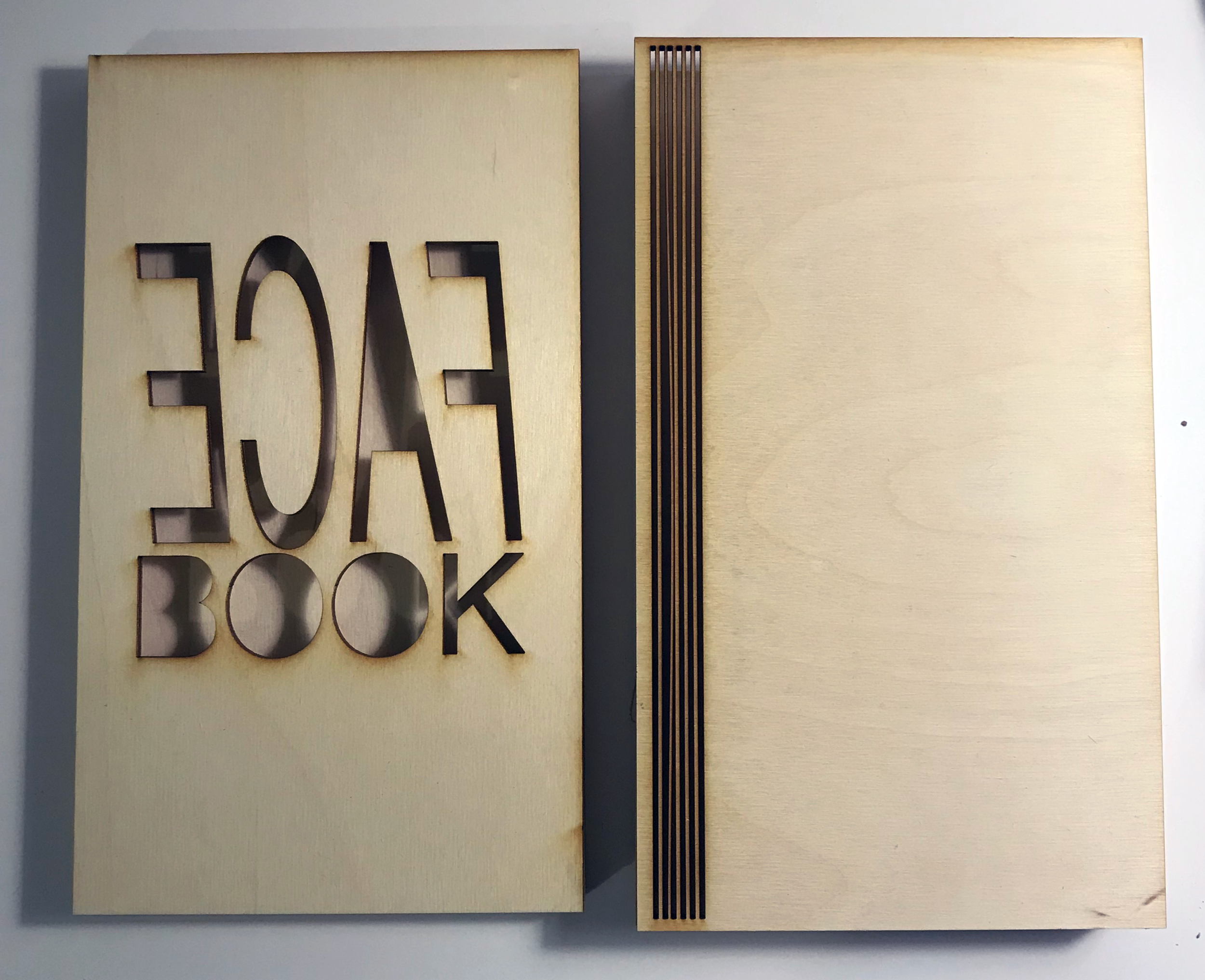 Jeanette Wells, Face Book structure, laser-cut wood, 5 in x 9 in x 1.5 in, 2019.