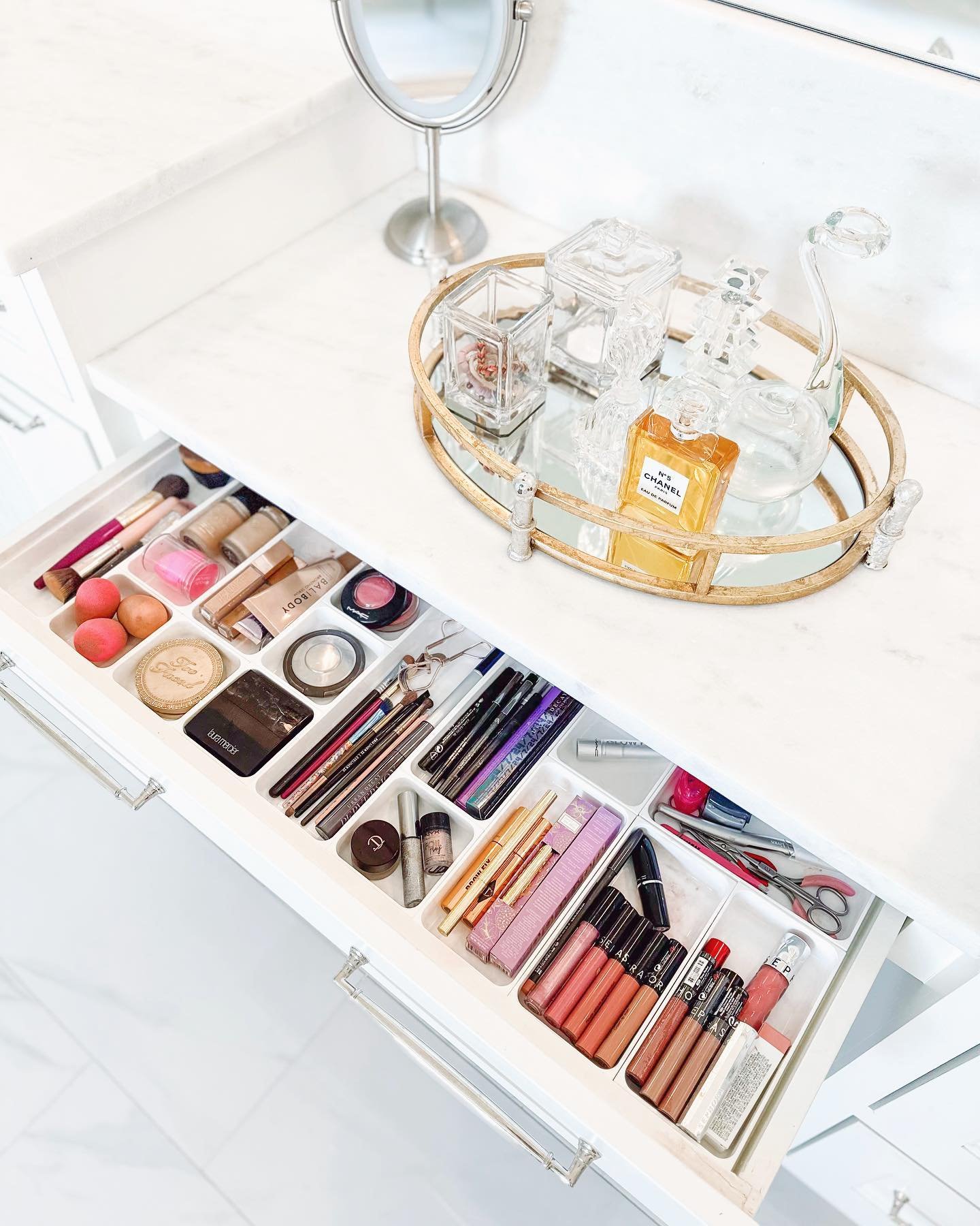 Glam Time! 💄 We say it&rsquo;s ok to have something on the bathroom counter when it&rsquo;s Chanel No. 5.  And we LOVE these shallow, white containers for a makeup drawer that is ready for a night out!