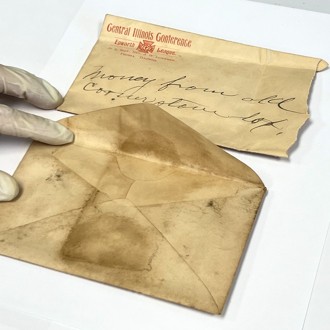 The envelope at the bottom of the photo held the upper envelope containing five coins.