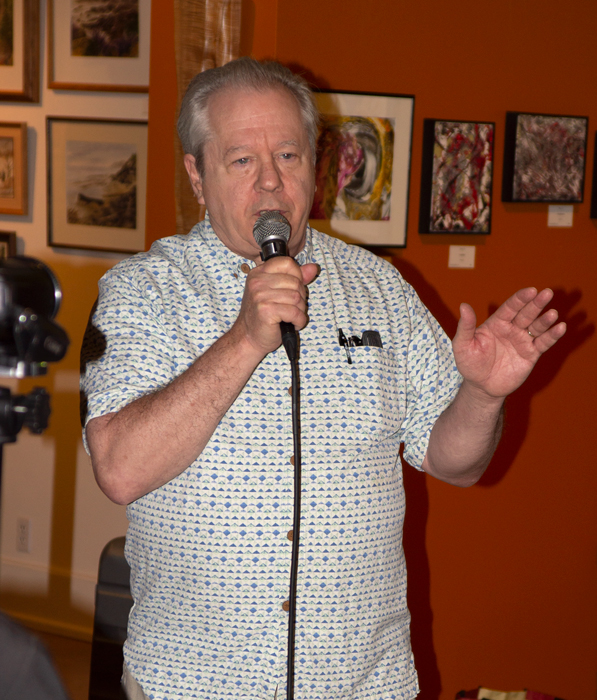 Grady Tarbutton promotes PhotoZone to the art walk crowd.