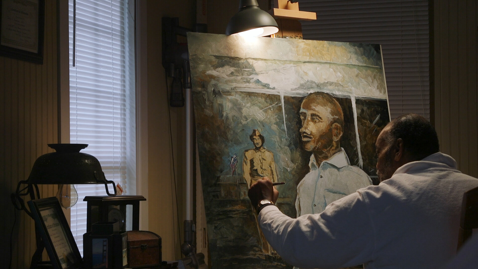  Artist Napolean Hill, working on a portrait of Mrs. Sarah Keys Evans, and her father, whom she credits with encouraging her to take up the legal battle. Mr. Hill paints the details on her Army Corp uniform.  Photo courtesy of Morgan Potts  