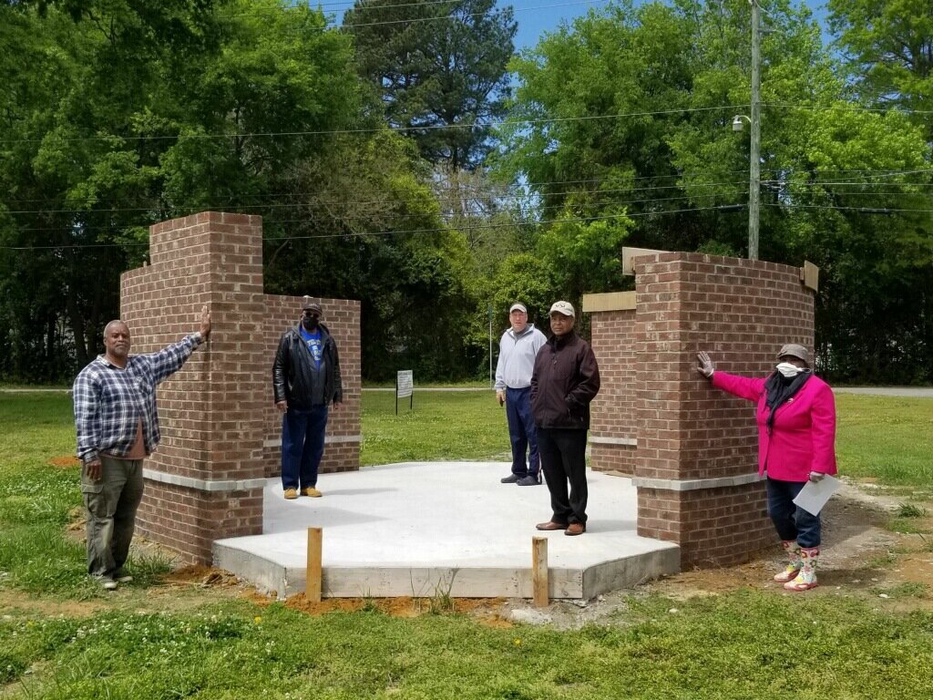  The SKE Project Team stand socially distanced, admiring the plaza, which is near completion.  Photo courtesy of Dr. Ervin Griffin  