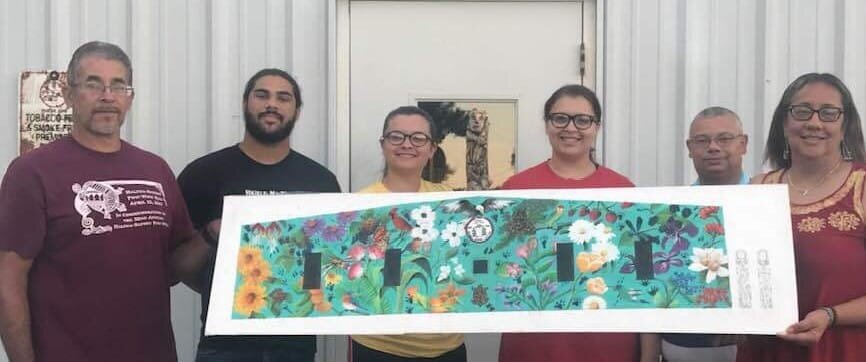  (L to R) Phillip Harley, Matthew Richardson, Tribal Princess Lelonnie Caison, Angelina Caison, Marvin “Marty” Richardson, and Karen Harley display the rendering for the multipurpose building mural and sculptures.  Photo courtesy of Karen Harley  