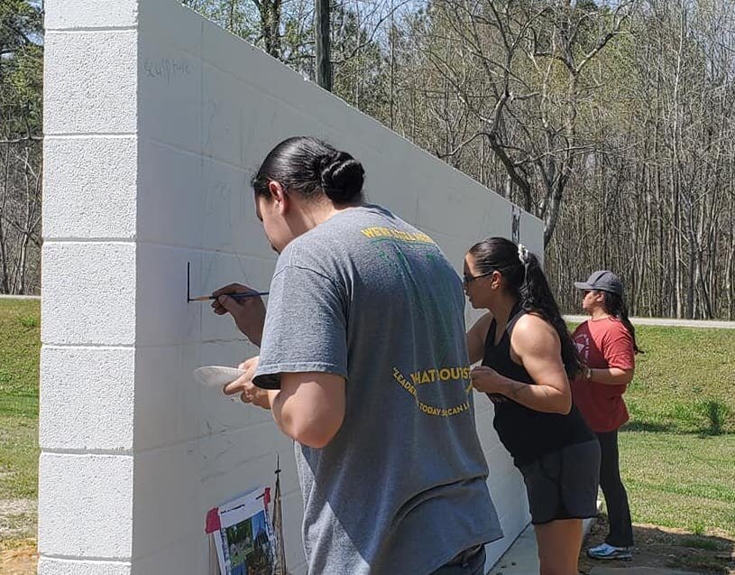  More community members help darken the line drawings to make them more visible for the painting process.  Photo courtesy of Karen Harley  