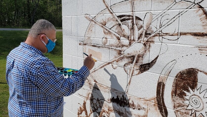  Project Manager, Dr. Marvin “Marty” Richardson, adds some of the first color.  Photo courtesy of Karen Harley  